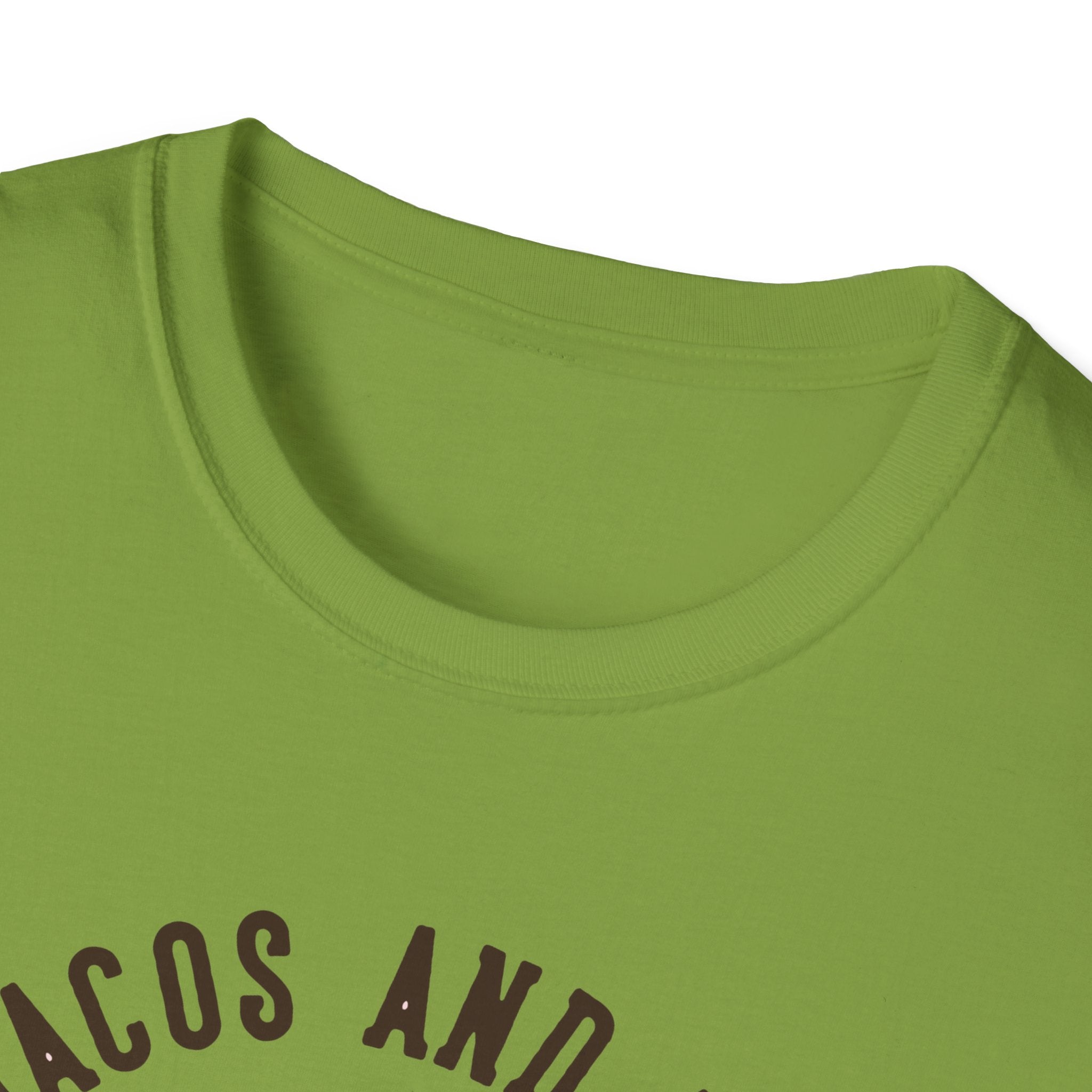 Green t-shirt with the partially visible text "Feed Me Tacos and Tell Me I'm Pretty" in black letters, perfect for taco enthusiasts. Its subtle nod might just be the missing piece for your Taco Tuesdays ensemble.