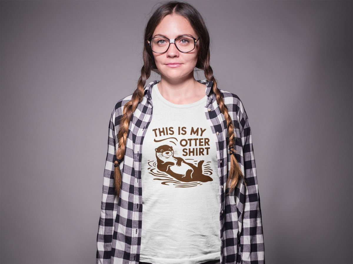 'This Is My Otter Shirt' t-shirt in white, woman wearing it in a plaid overshirt, funny animal pun gift