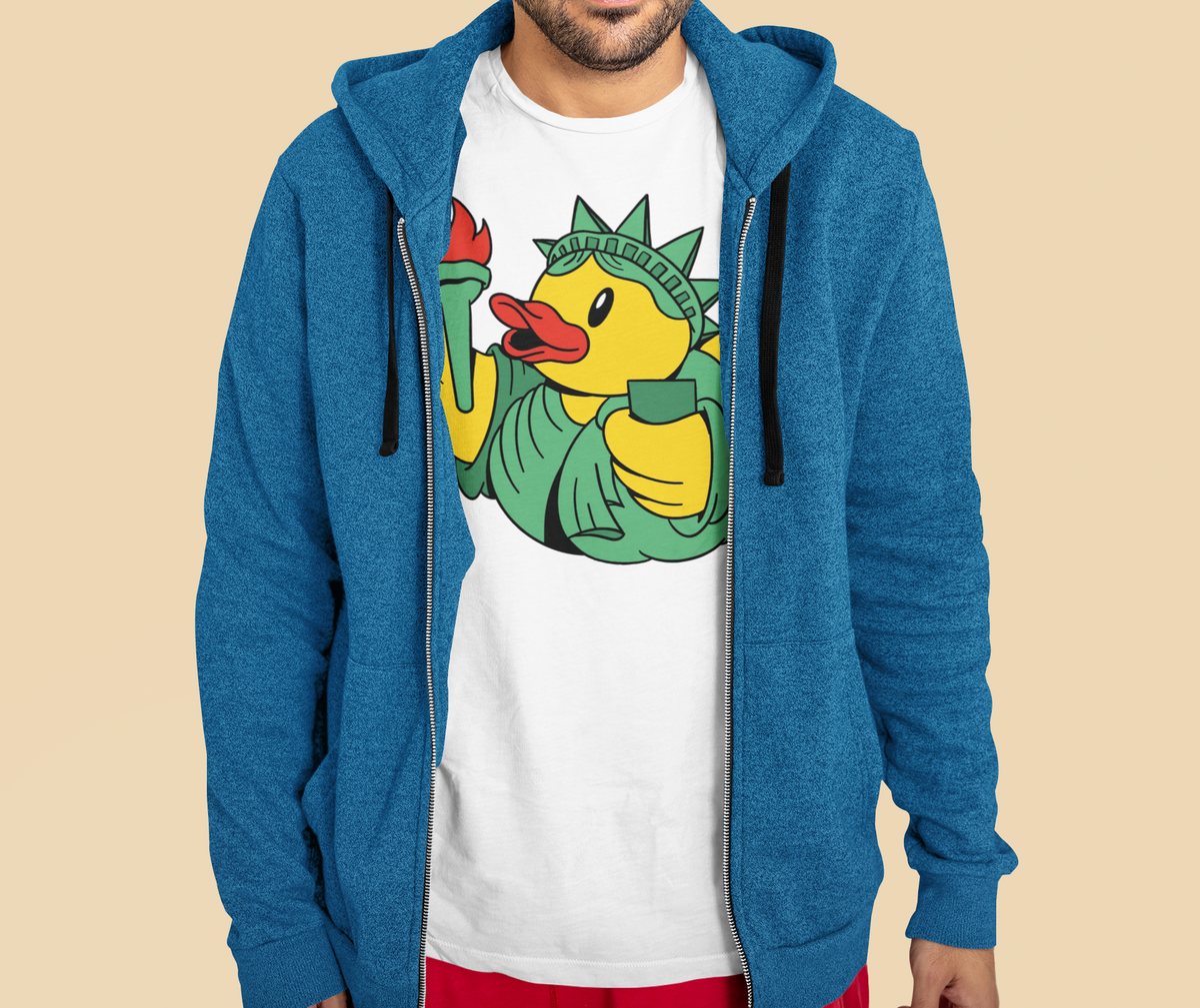 Liberty duck t-shirt in white, man model wearing it under a blue zip hoodie, funny patriotic duck gift