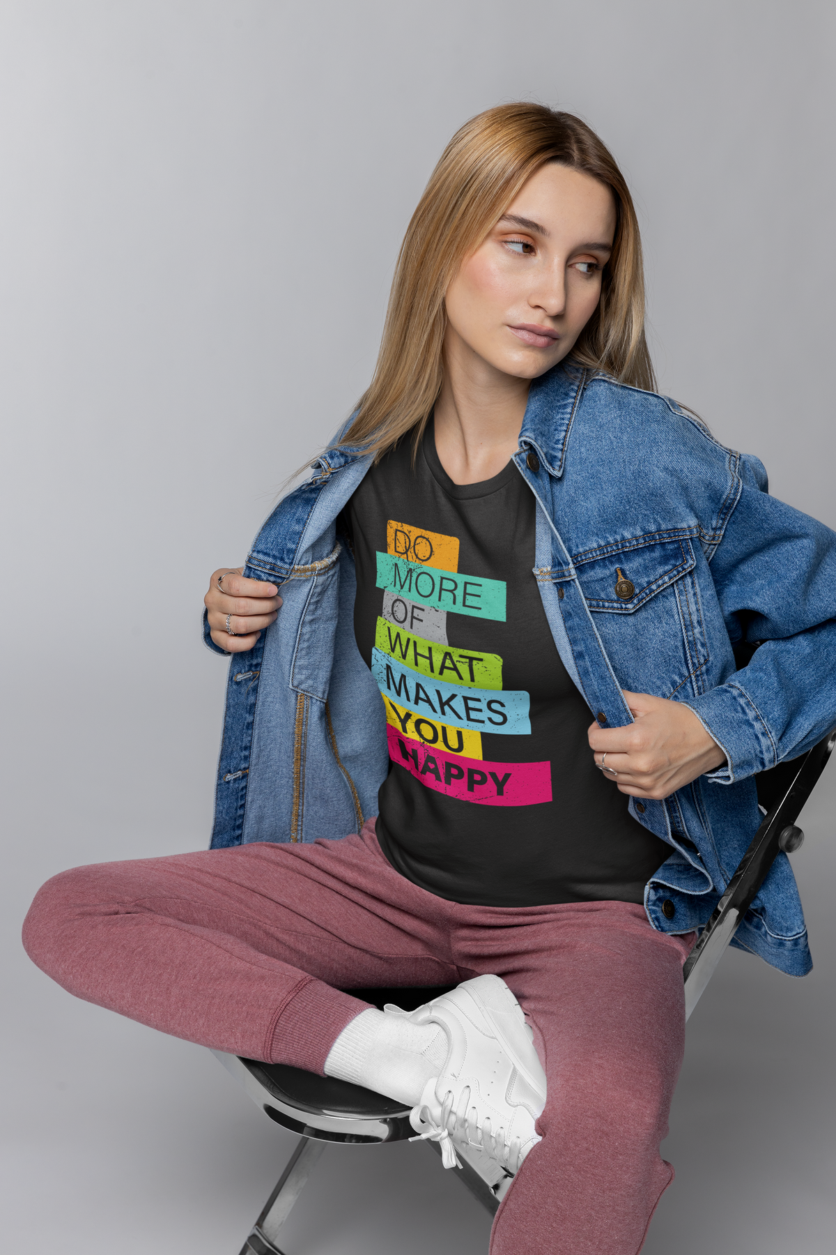'Do More of What Makes You Happy' T-shirt in black, woman wearing it with a denim jacket, gift
