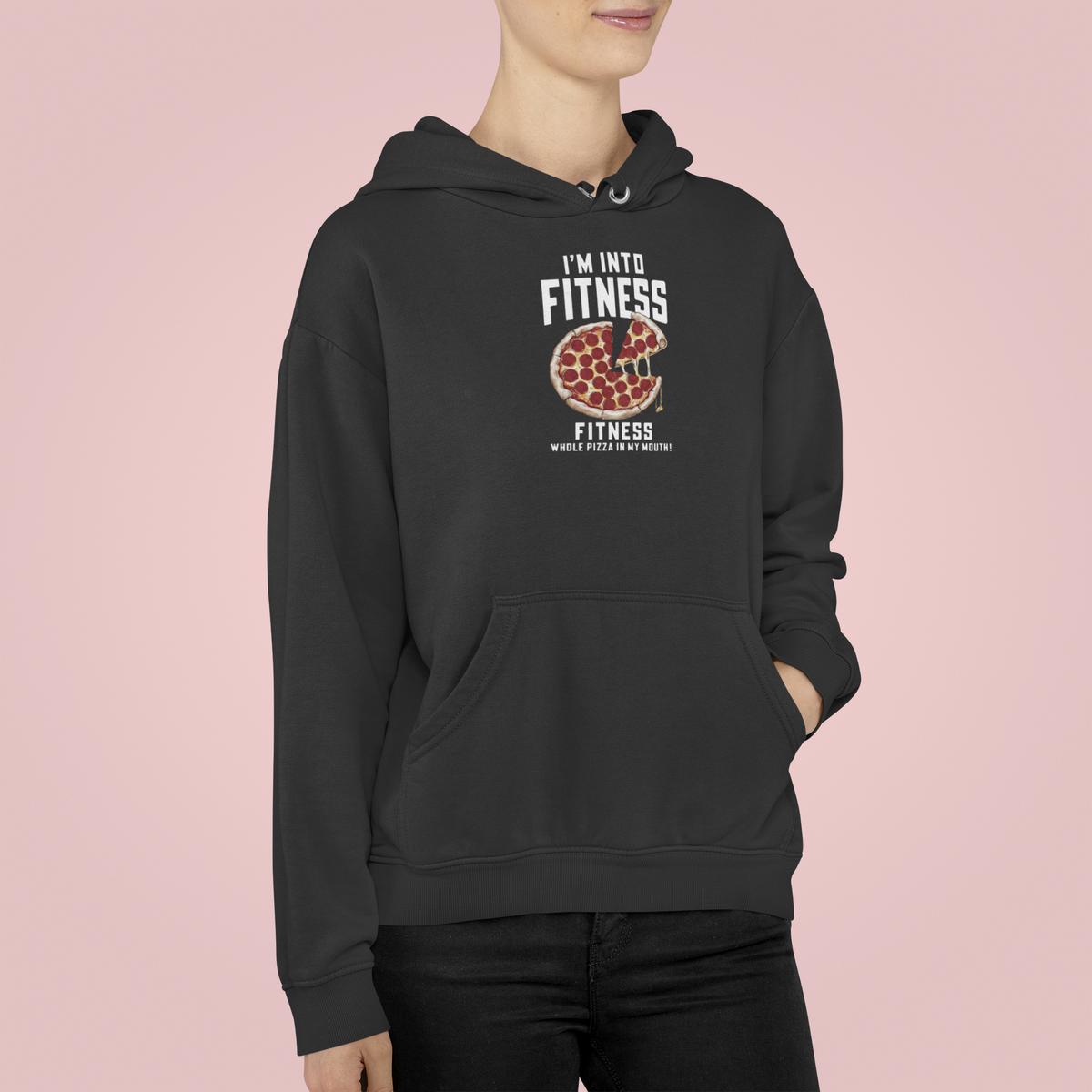 'I'm Into Fitness' pizza pun hoodie in dark heather, man wearing it against a pink backdrop, funny foodie gift