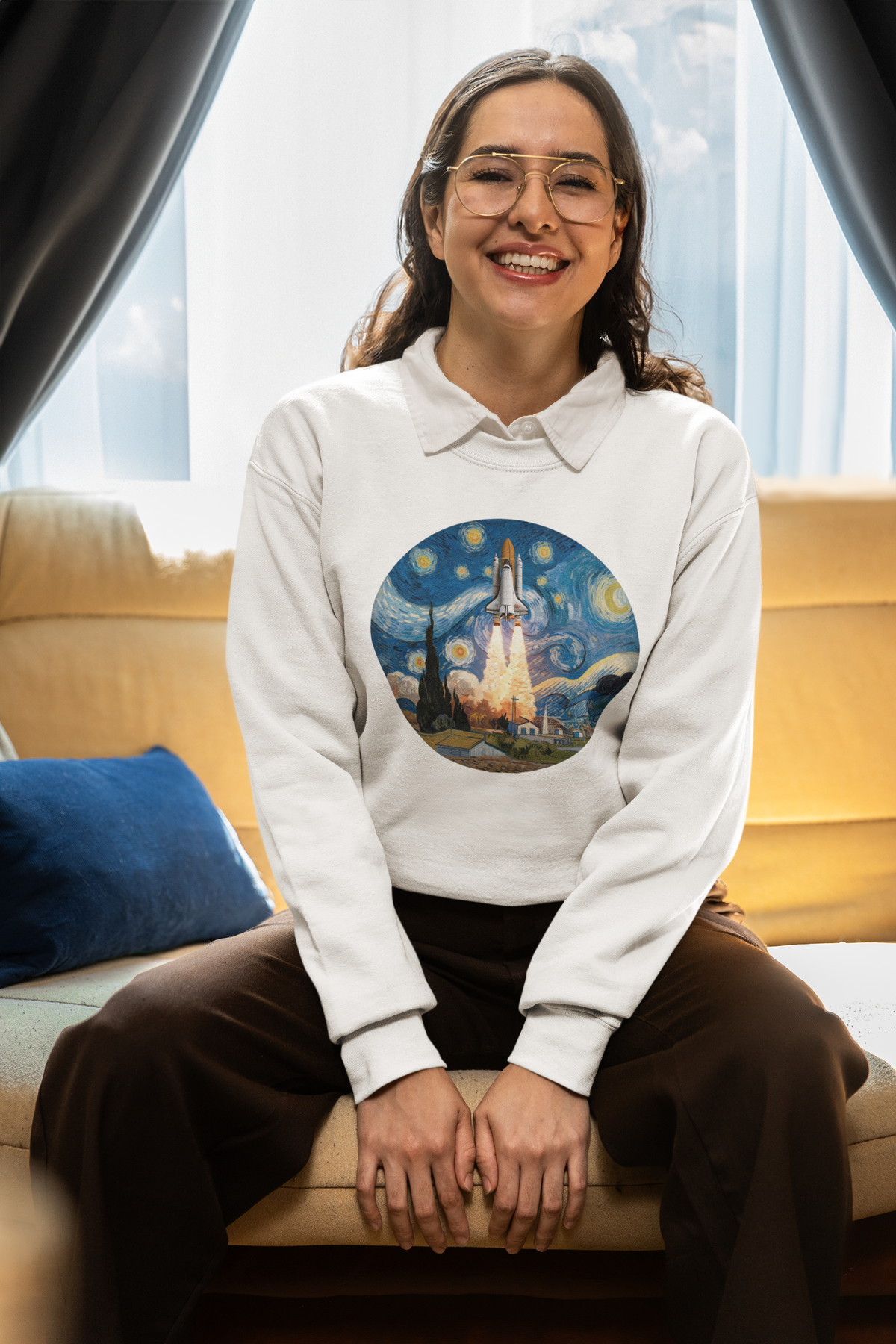Van Gogh Spaceship Sweatshirt in white, smiling woman sitting indoors on couch, starry night rocket art top