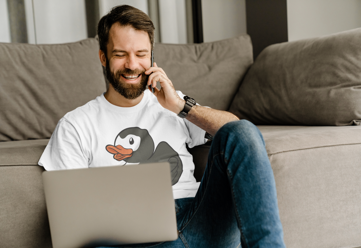 Super Duck t-shirt in white, man model wearing it on a couch with a laptop, funny gift for duck lovers