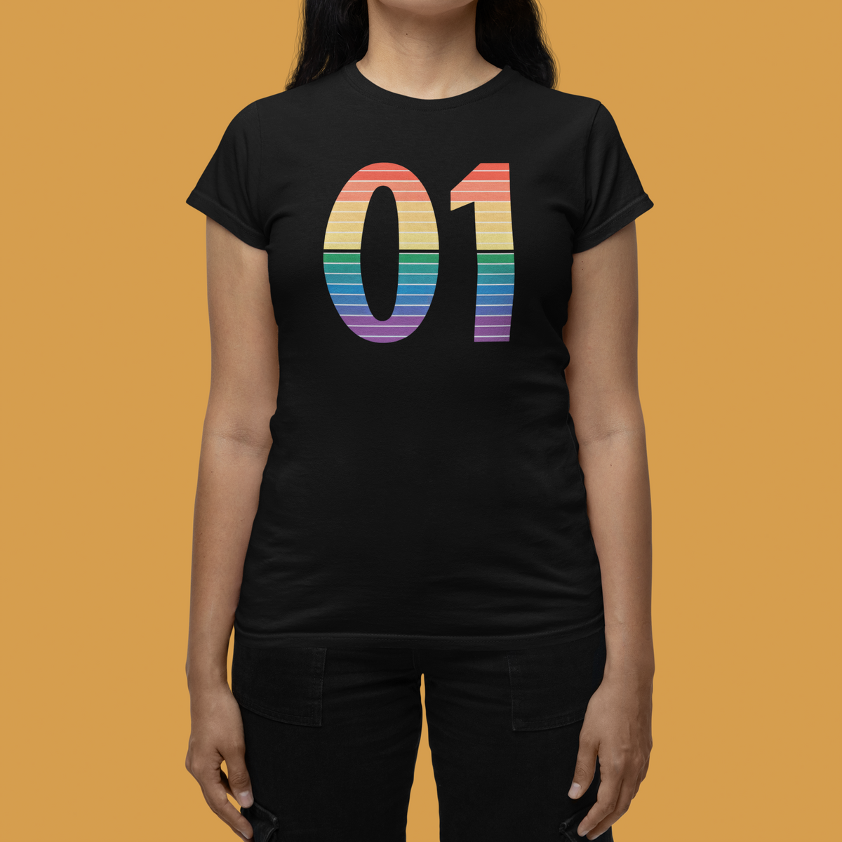01 Binary black women's tee with rainbow print worn by a woman, orange background, funny coder gift