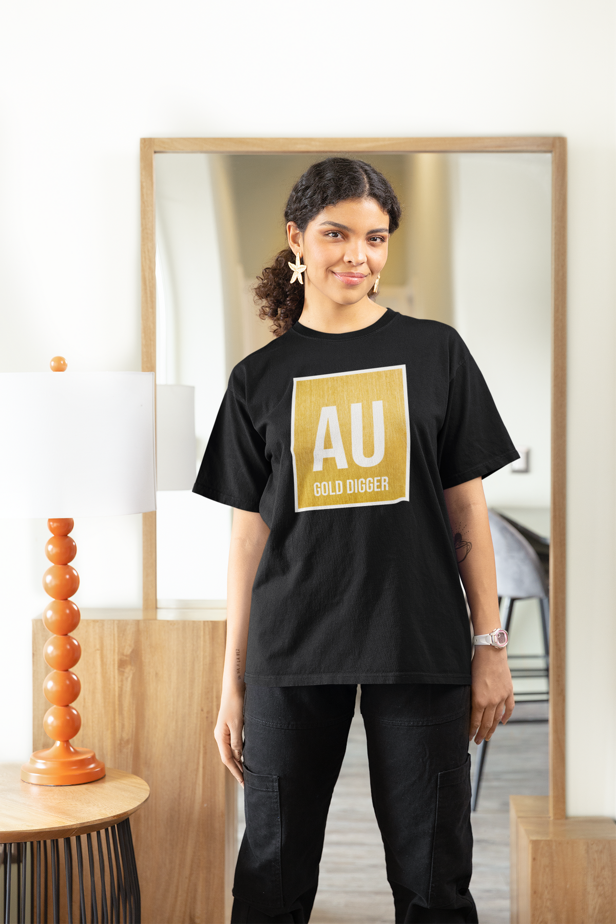 'AU Gold Digger' women's fitted t-shirt in black, woman wearing it oversized at home, cozy chemistry pun gift