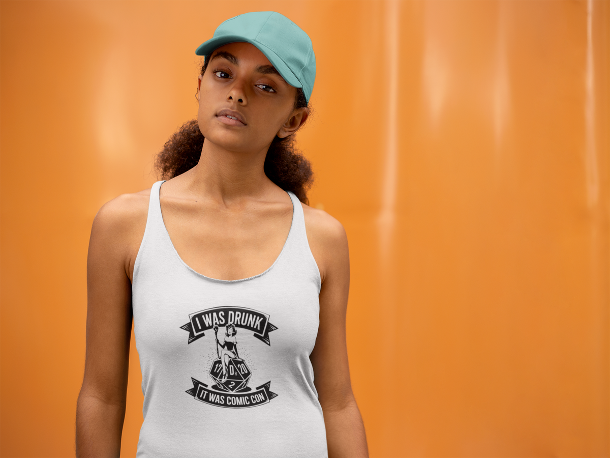 'Comic Con Drunk Chronicles Tank' in white, woman by an orange wall, Tank Top mockup, Geekpsters