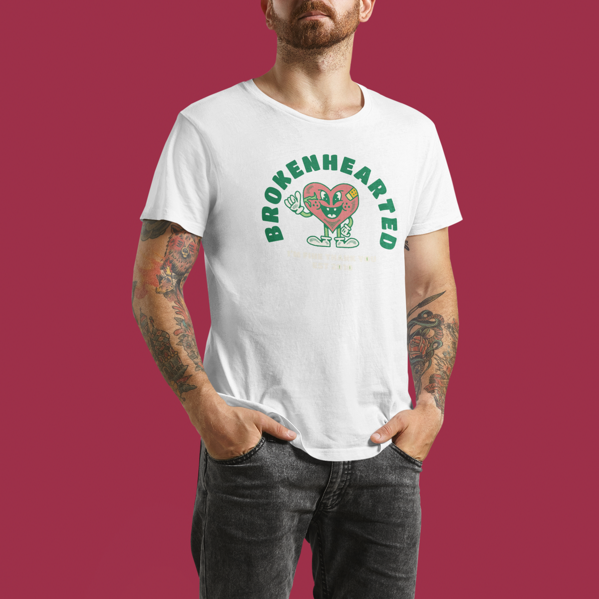 'Brokenhearted But Keeps On Rocking' t-shirt in white, tattooed man wearing it, funny rock music gift