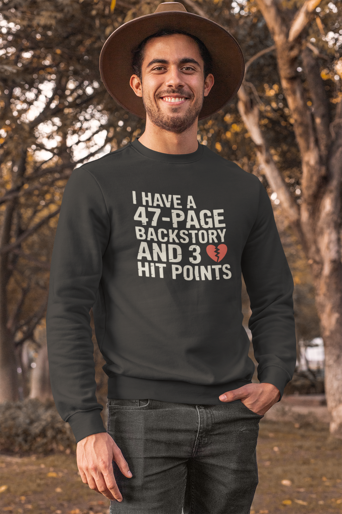 'I Have a 47-Page Backstory' black sweatshirt worn by man in hat outdoors in park, funny RPG gift
