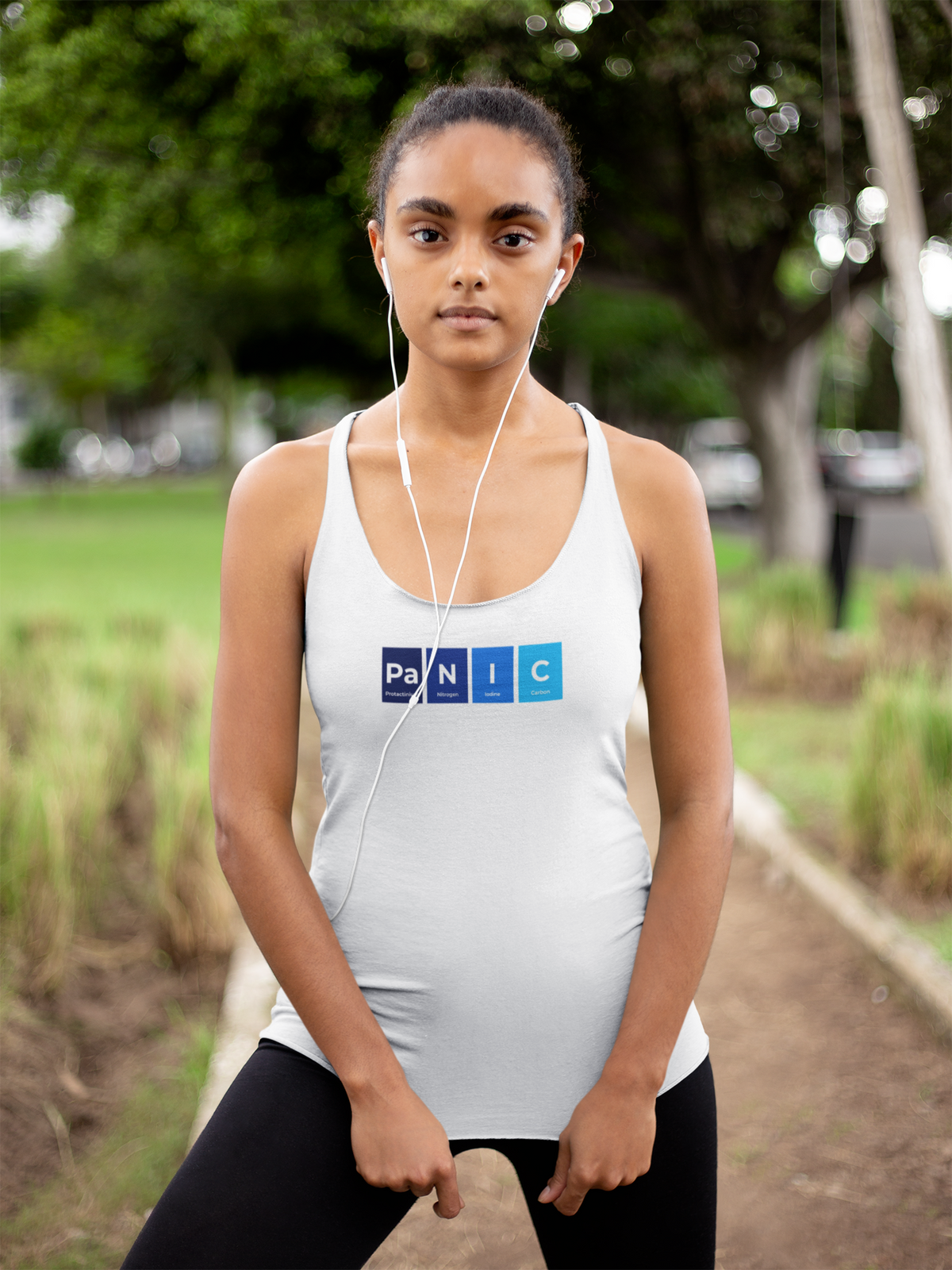 'Pa-N-I-C Periodic Table Women's Tank' in white, woman in a park, Tank Top mockup, Geekpsters