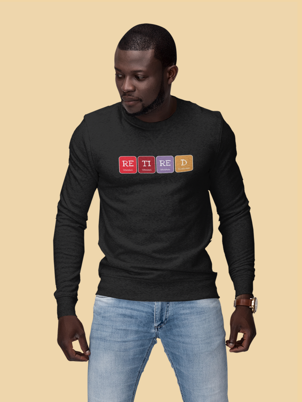 'Retired' periodic table sweatshirt in black, man wearing it on tan background, funny retirement gift