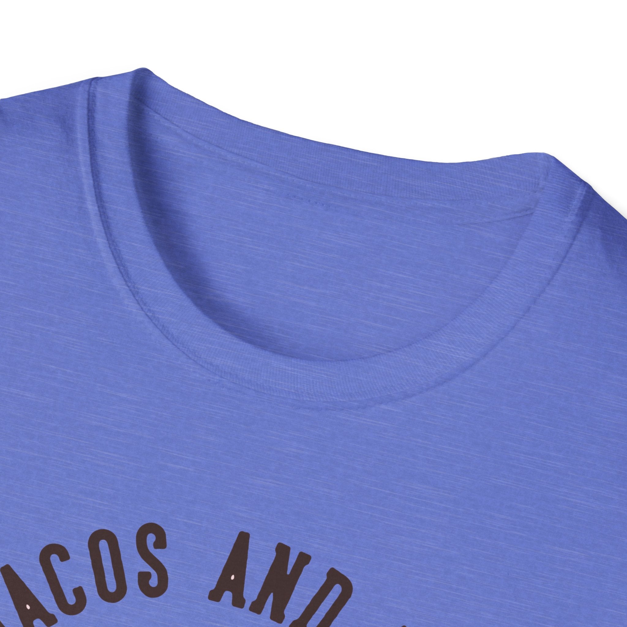 Close-up of a blue T-shirt with partially visible black text, "Feed Me Tacos and Tell Me I'm Pretty," perfect for taco lovers and celebrating Taco Tuesdays in style.