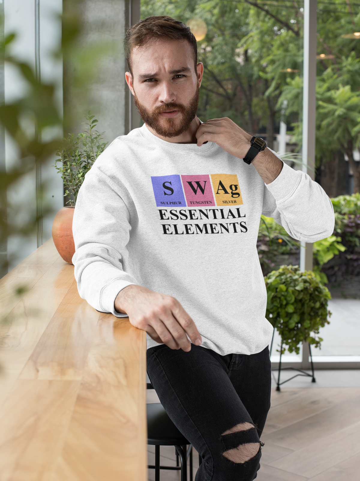 'SWAg, Essential Elements' periodic table sweatshirt in white, man wearing it outdoors, funny science gift