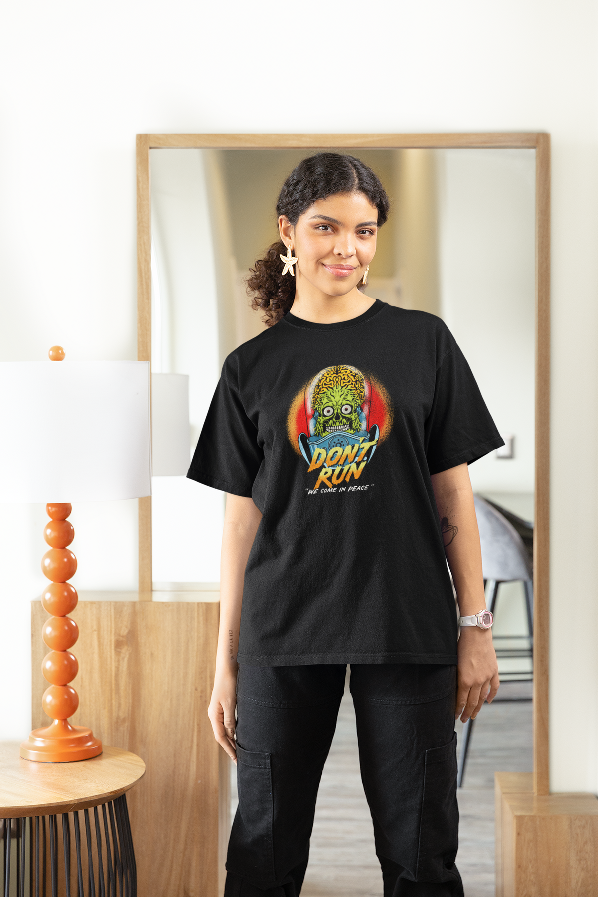 "Don't Run" zombie graphic tee in black, woman wearing it at home, funny horror gift for women