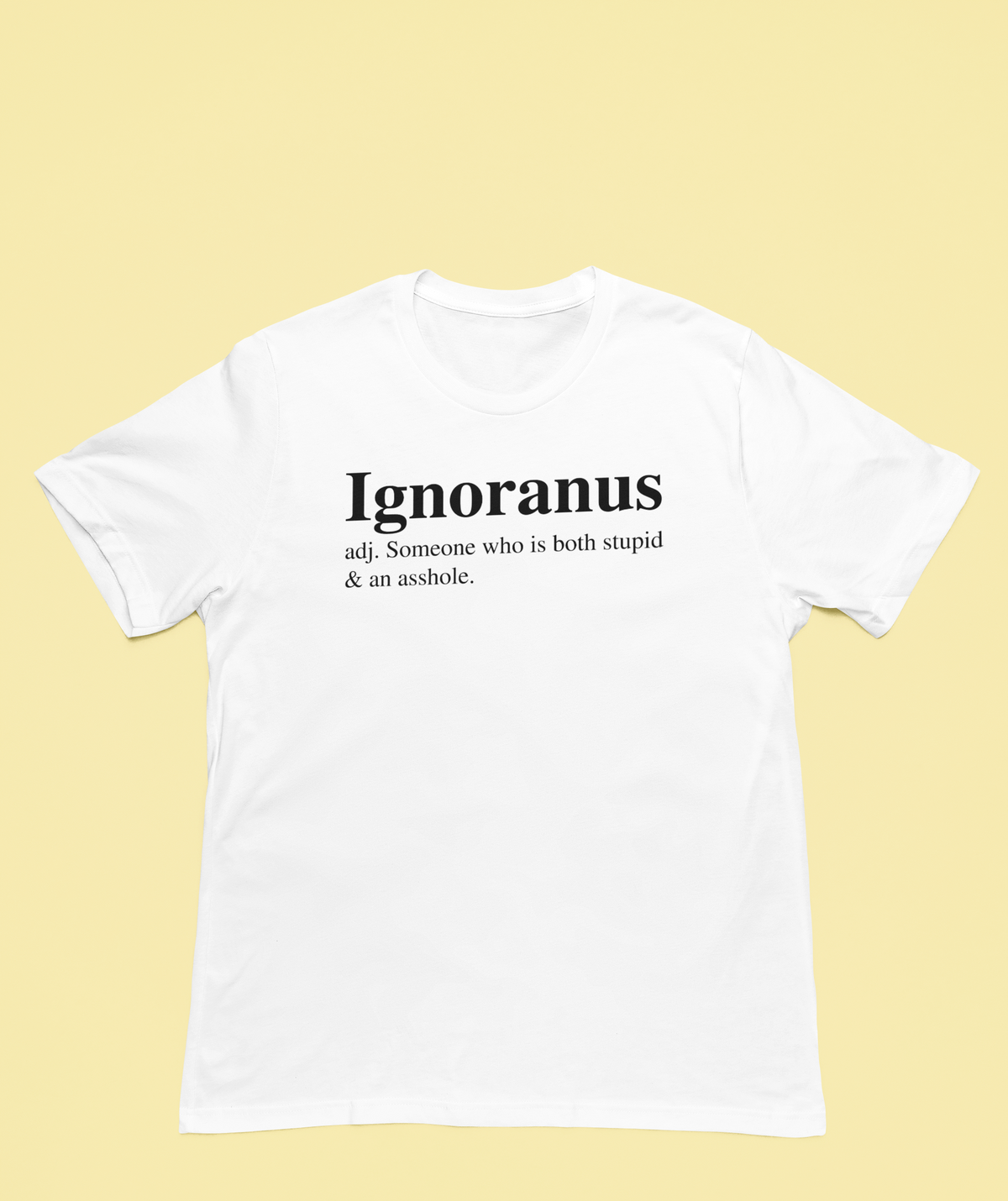 'Ignoranus' definition T-shirt in white, flat lay on pale yellow background, sarcastic insult tee