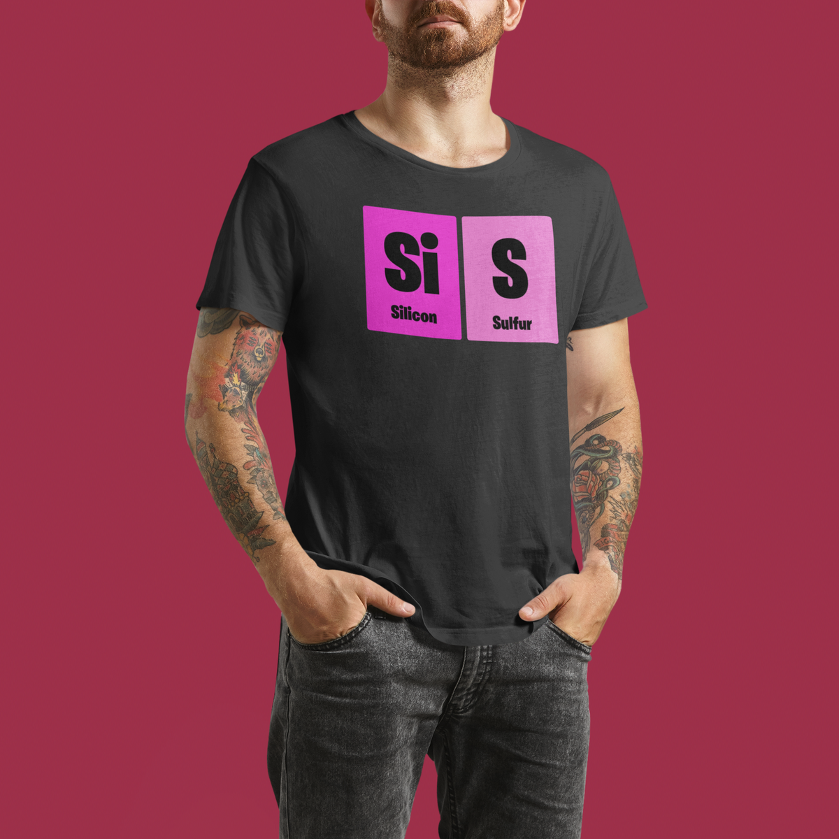 'Sis' periodic table t-shirt in heather grey, tattooed man wearing it on red background, funny gift