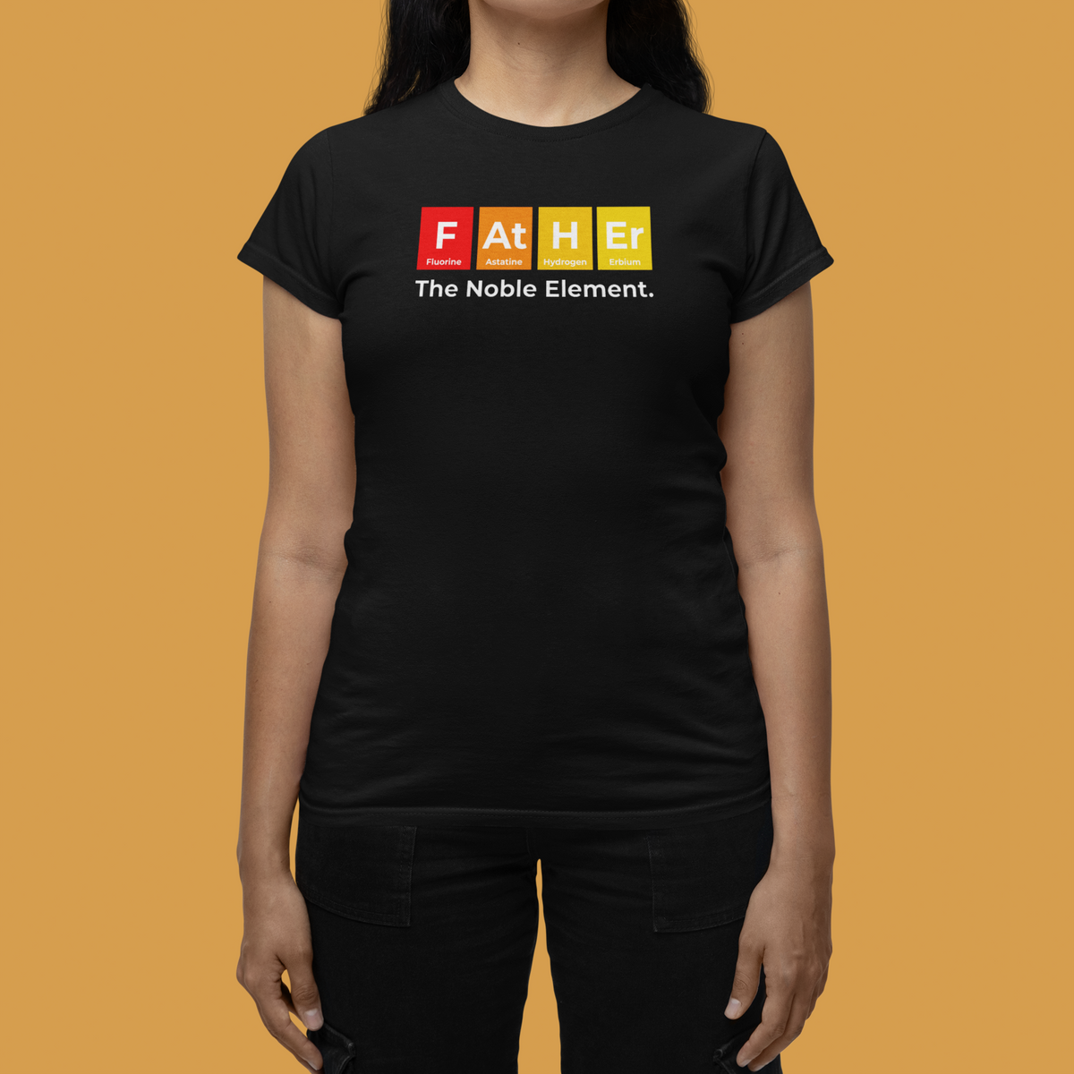 'Father: The Noble Element' women's tee in black, woman on mustard background, funny chemistry tee