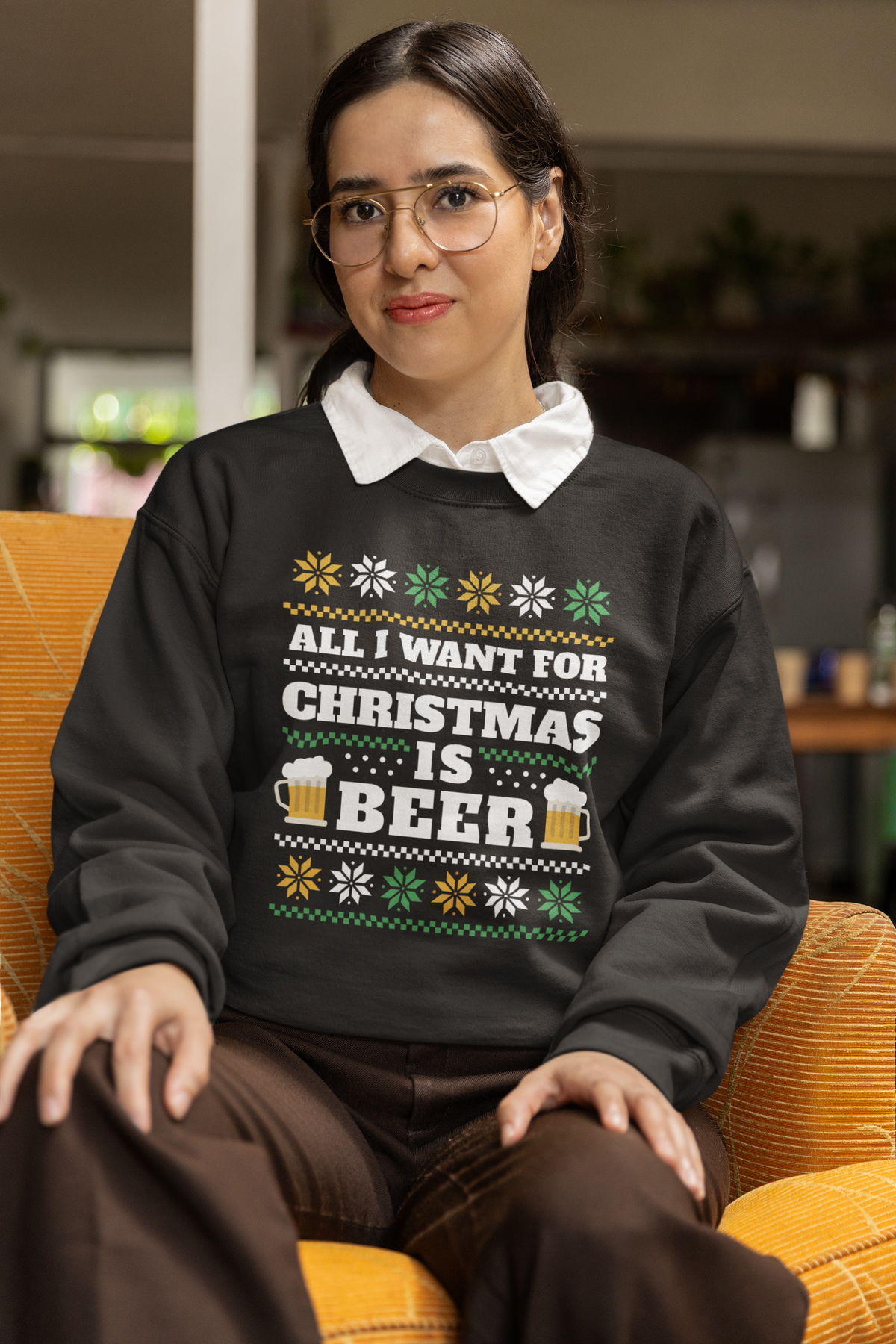 'All I Want For Christmas Is Beer' crewneck in black, woman wearing it seated indoors, funny gift