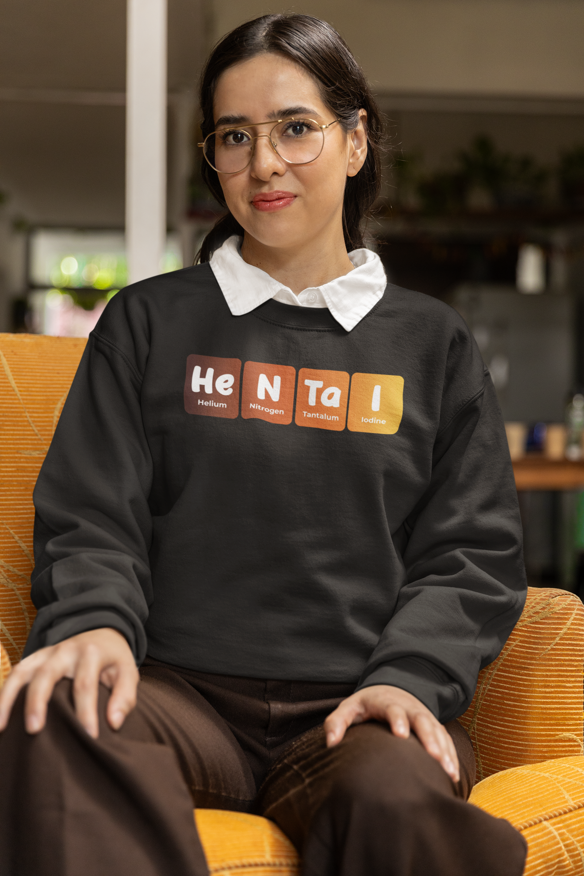 'Hentai' periodic table sweatshirt in black, woman wearing it seated indoors, funny geeky anime gift