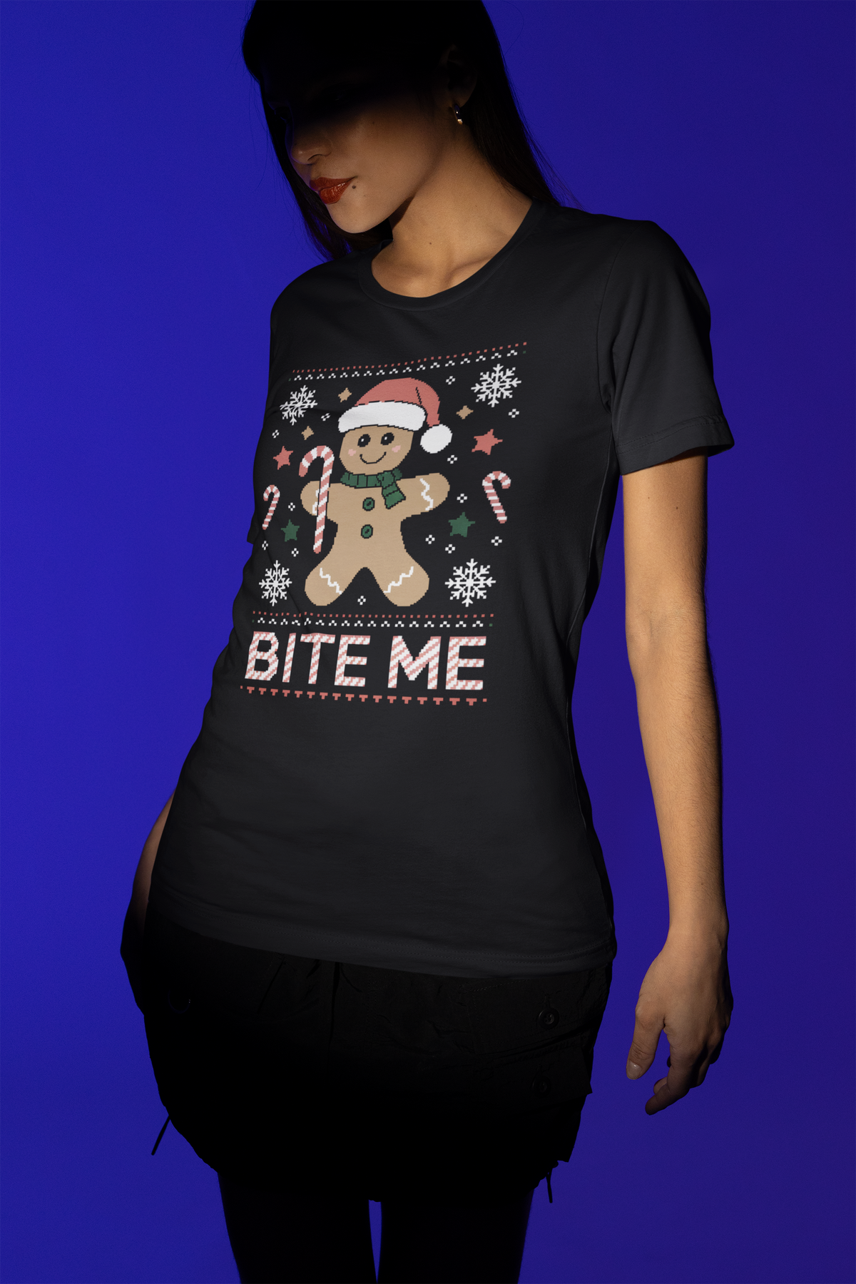 'Bite Me' gingerbread man t-shirt in black, woman modeling it studio shot, funny Christmas pun gift