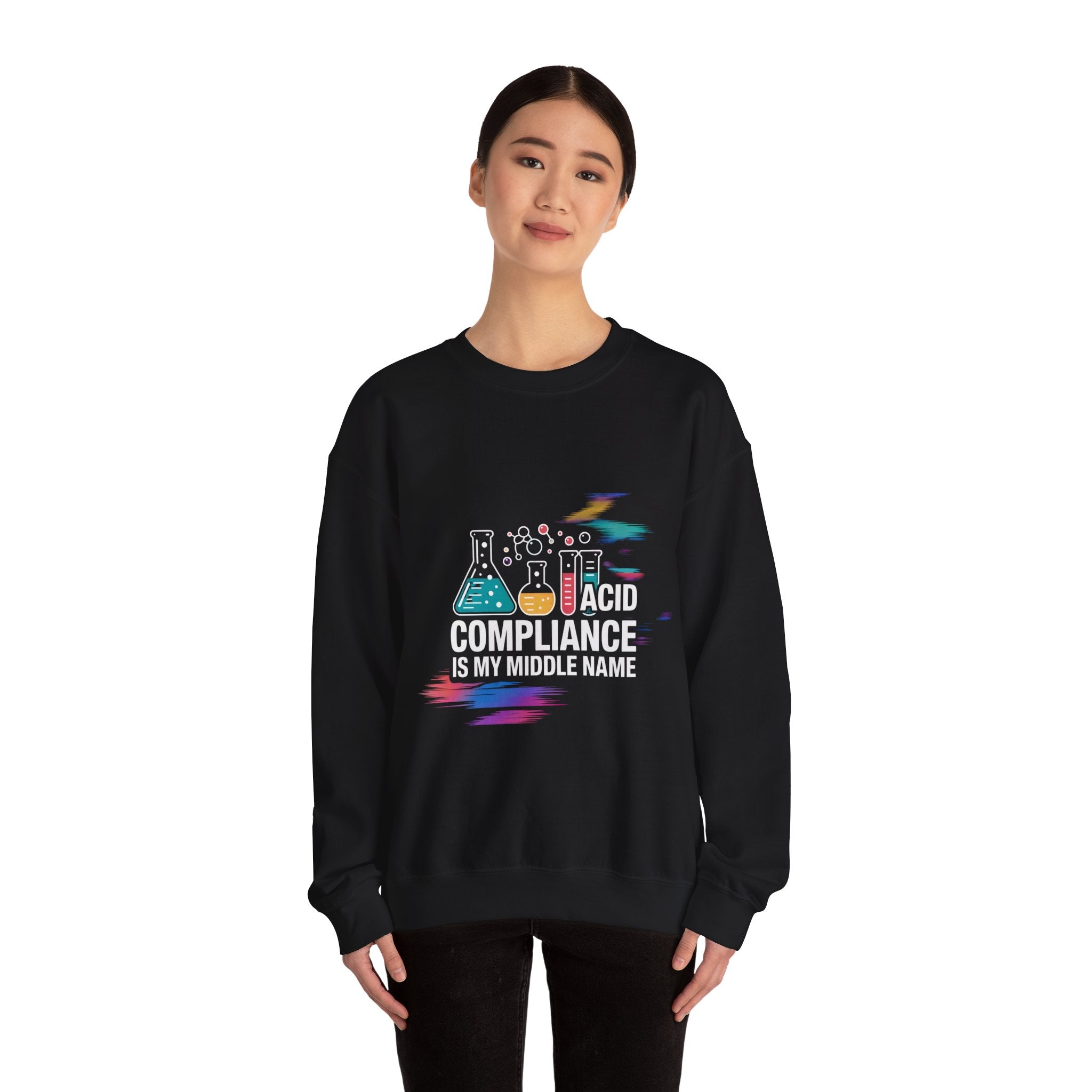 A person faces forward, wearing the "ACID Compliance Is My Middle Name" eco-friendly cotton sweatshirt featuring colorful sci-fi lab equipment graphics.