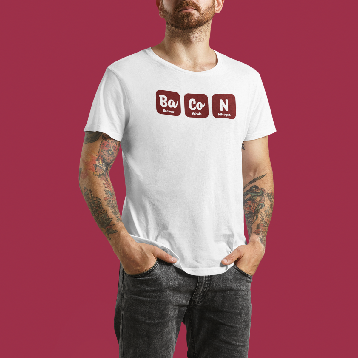 'Bacon' periodic table T-shirt in white, man wearing it against a red backdrop, science gift shirt