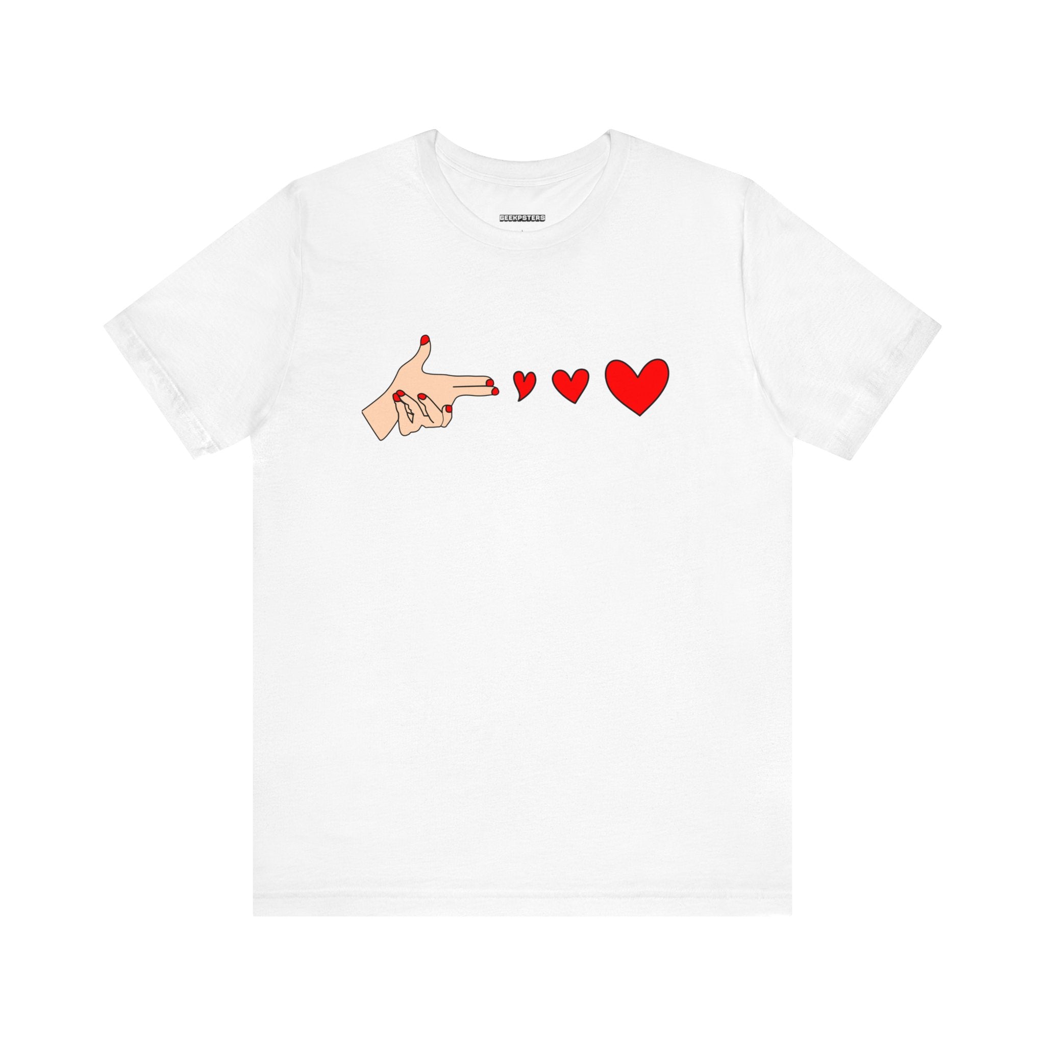 The Bang Bang T-Shirt features a bold graphic of a hand making a finger gun gesture, aimed at three red hearts of increasing size, on an ultra-soft, breathable white fabric.