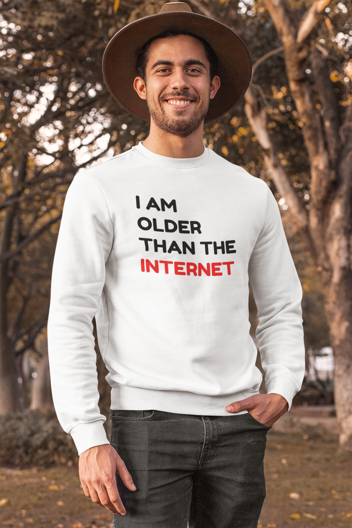 'I Am Older Than the Internet' sweatshirt in white, man wearing it outdoors in the city, funny retro pun gift