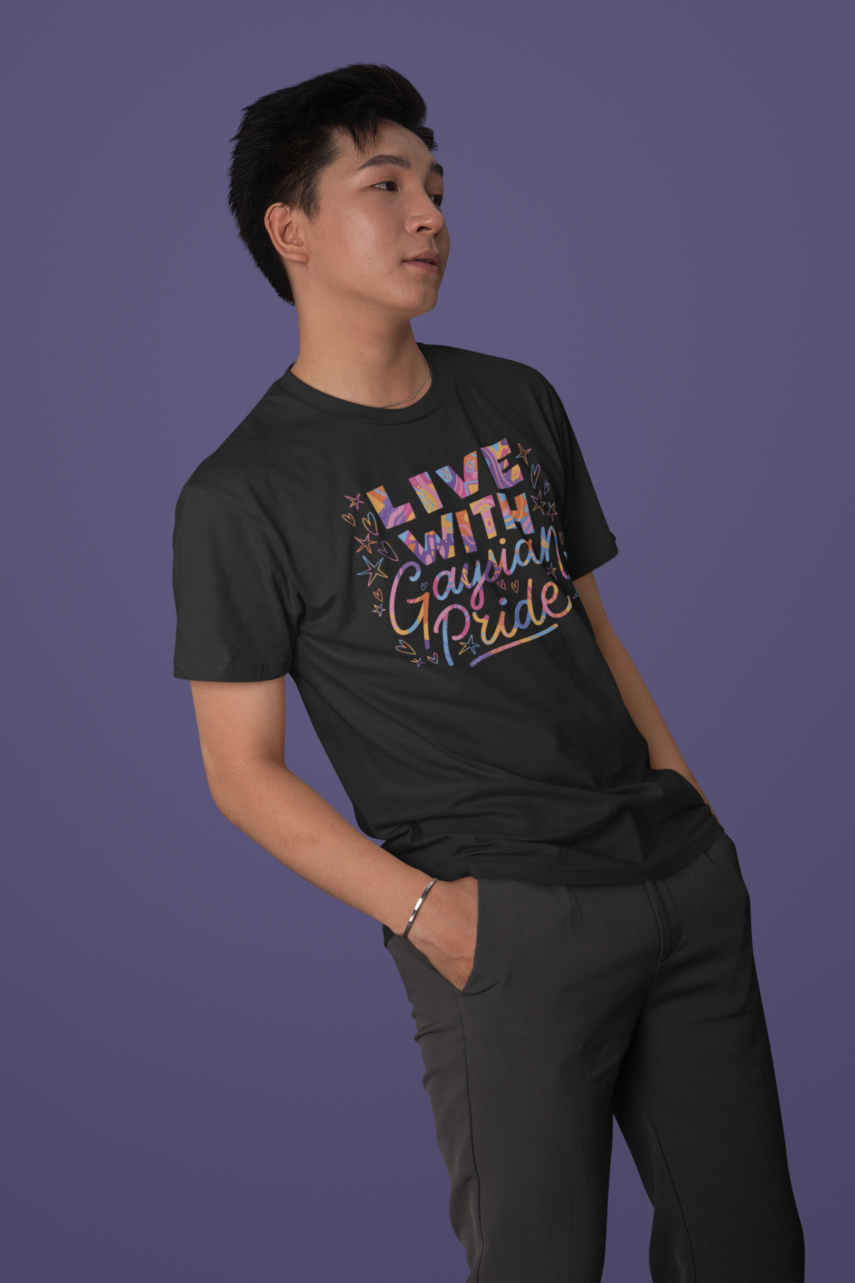 'Live with Gaysian Pride' T-shirt in black, man wearing it against a purple backdrop, pride gift shirt