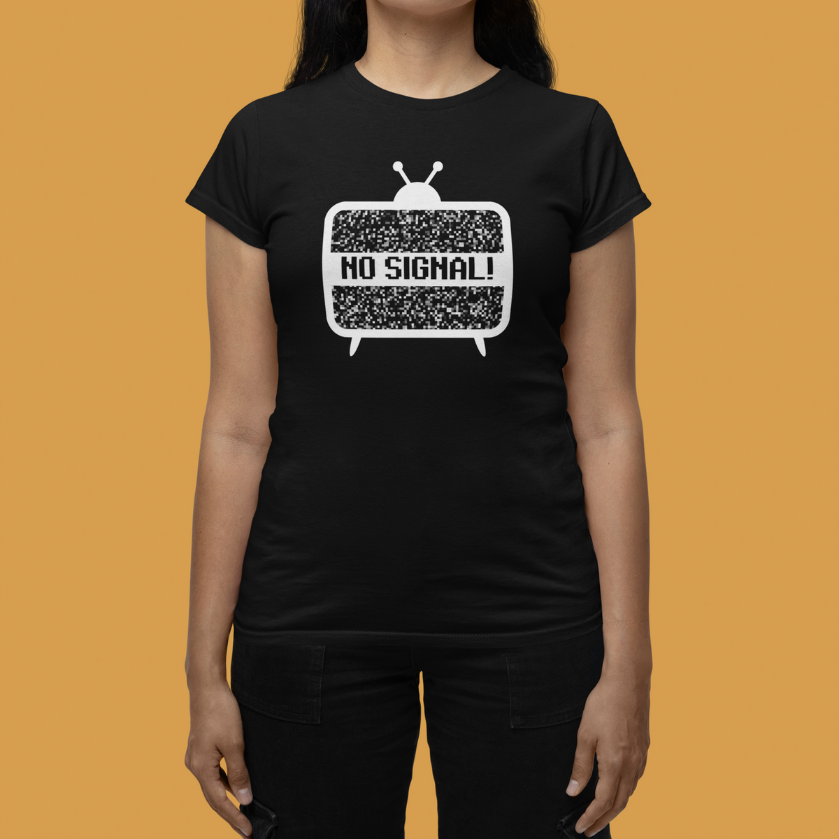 'No Signal' women's fitted t-shirt in black, woman wearing it against mustard backdrop, retro TV lover gift