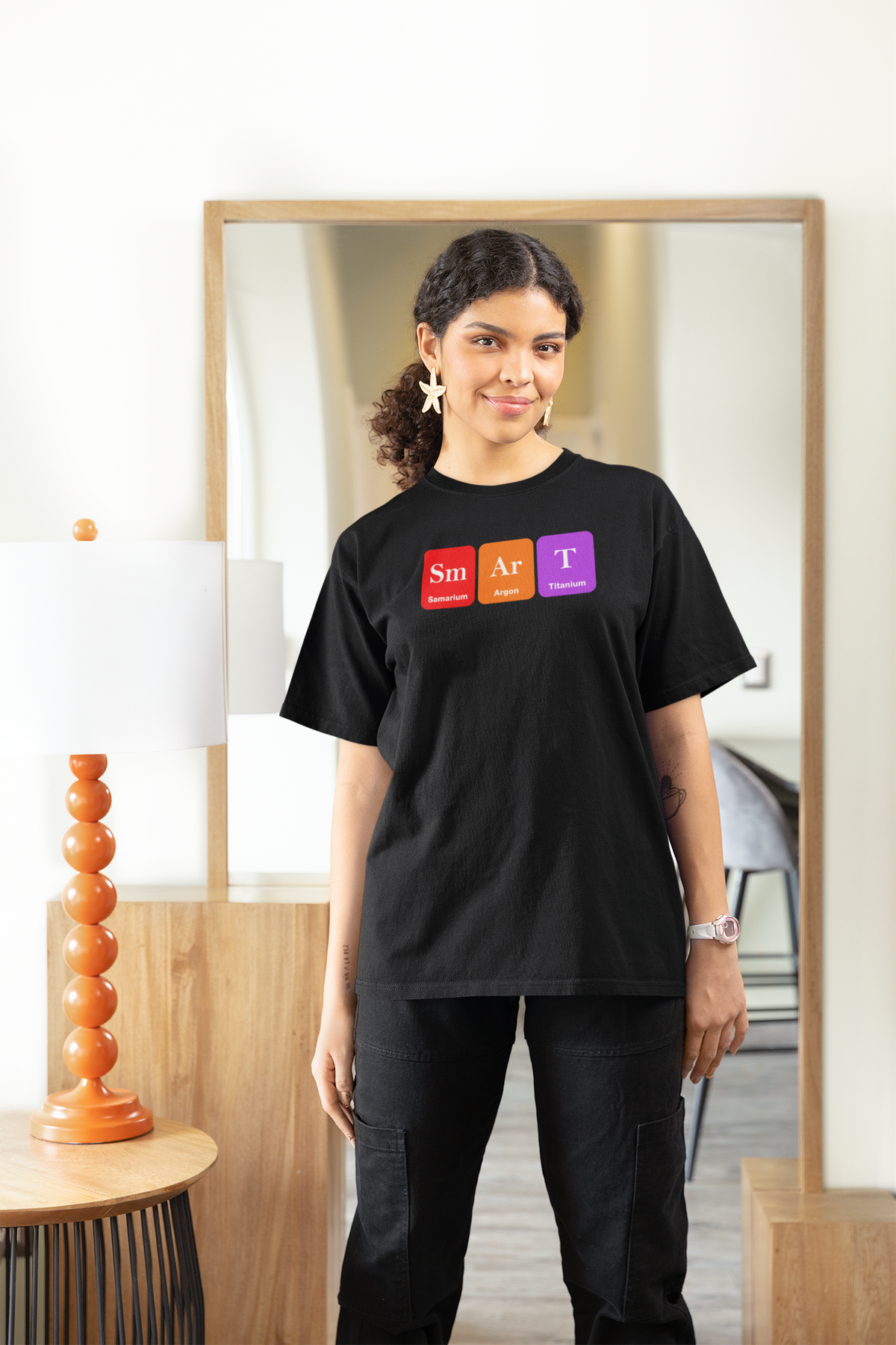 'Smart' periodic table women's t-shirt in black, woman standing indoors by a mirror, funny chemistry gift