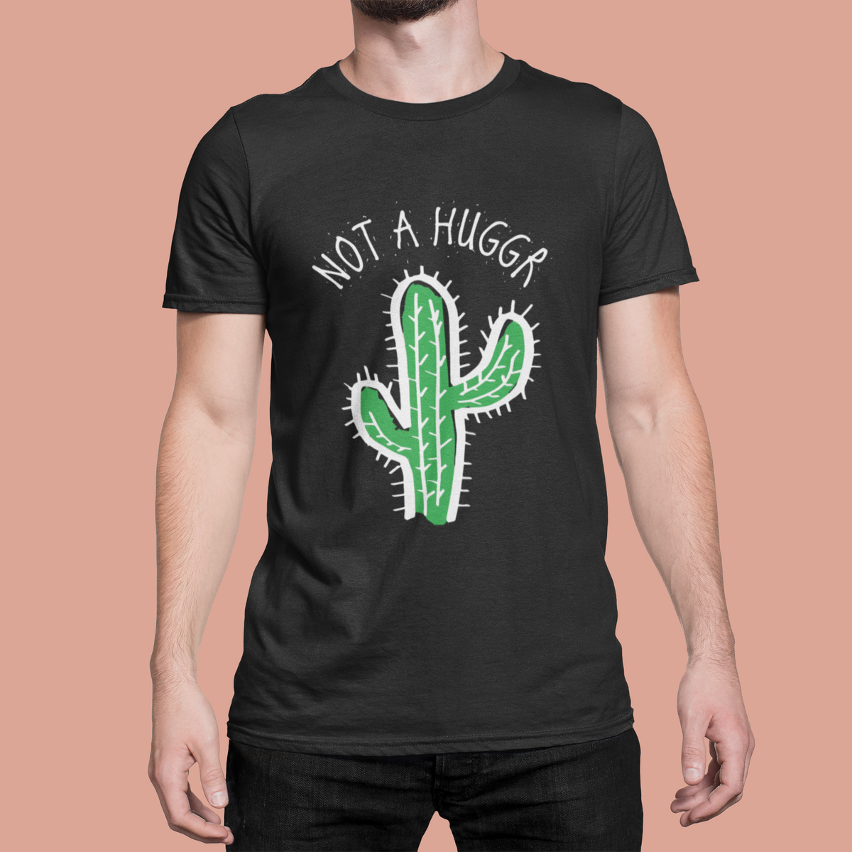 Not a Hugger cactus t-shirt in black, man wearing it against a coral background, funny sarcastic gift