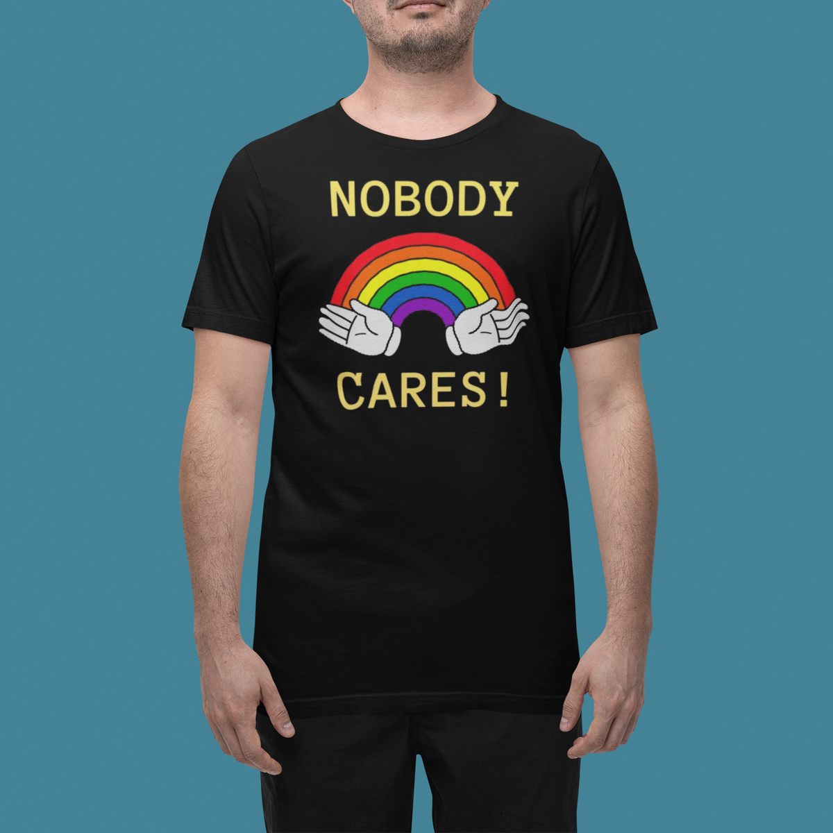 'Nobody Cares' t-shirt in black, man wearing it in a studio, T-Shirt mockup, Geekpsters