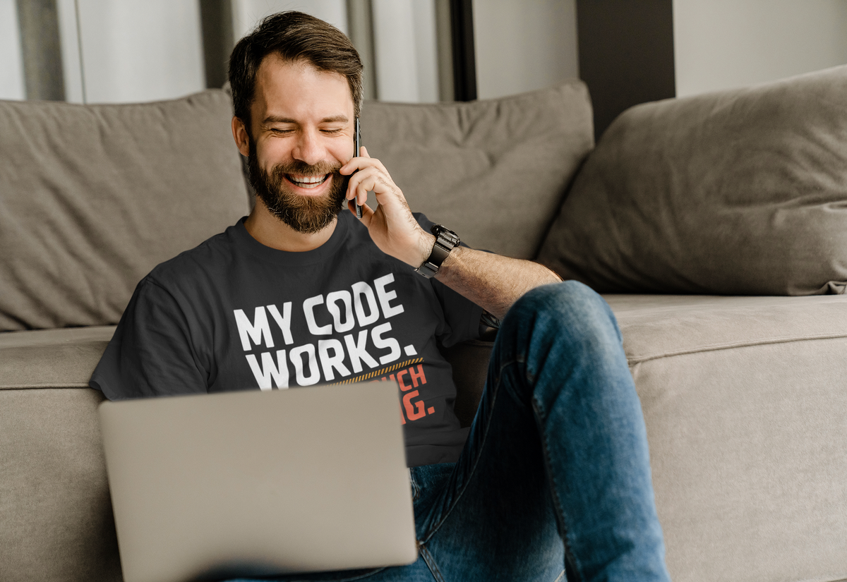 'My Code Works. Nobody Touch Anything.' black tee worn by man on couch calling, funny coder gift