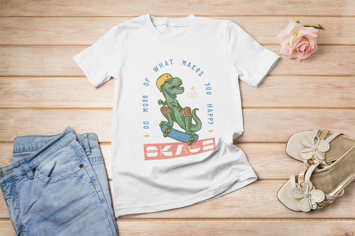 "Do More of What Makes You Happy" dino t-shirt in white, flat lay with jeans, funny skater lifestyle gift
