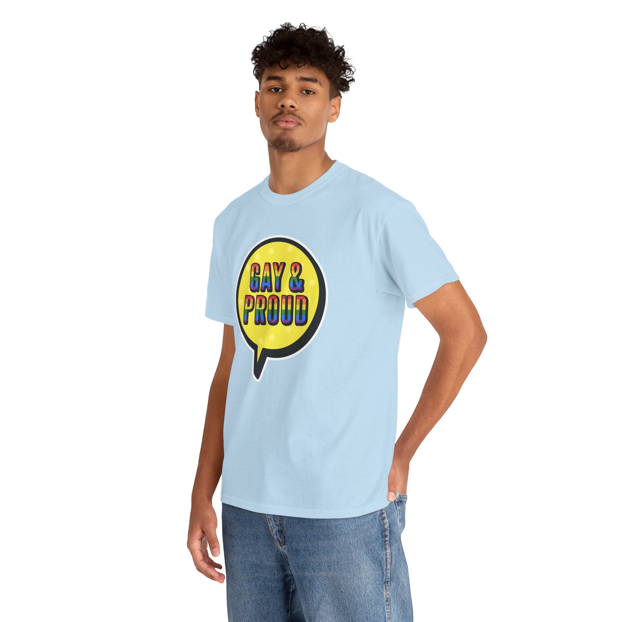 A person wearing the Gay & Proud T-Shirt, designed in light blue and crafted from comfortable cotton with a "Gay & Proud" speech bubble graphic, stands against a white background, making it ideal for everyday wear.