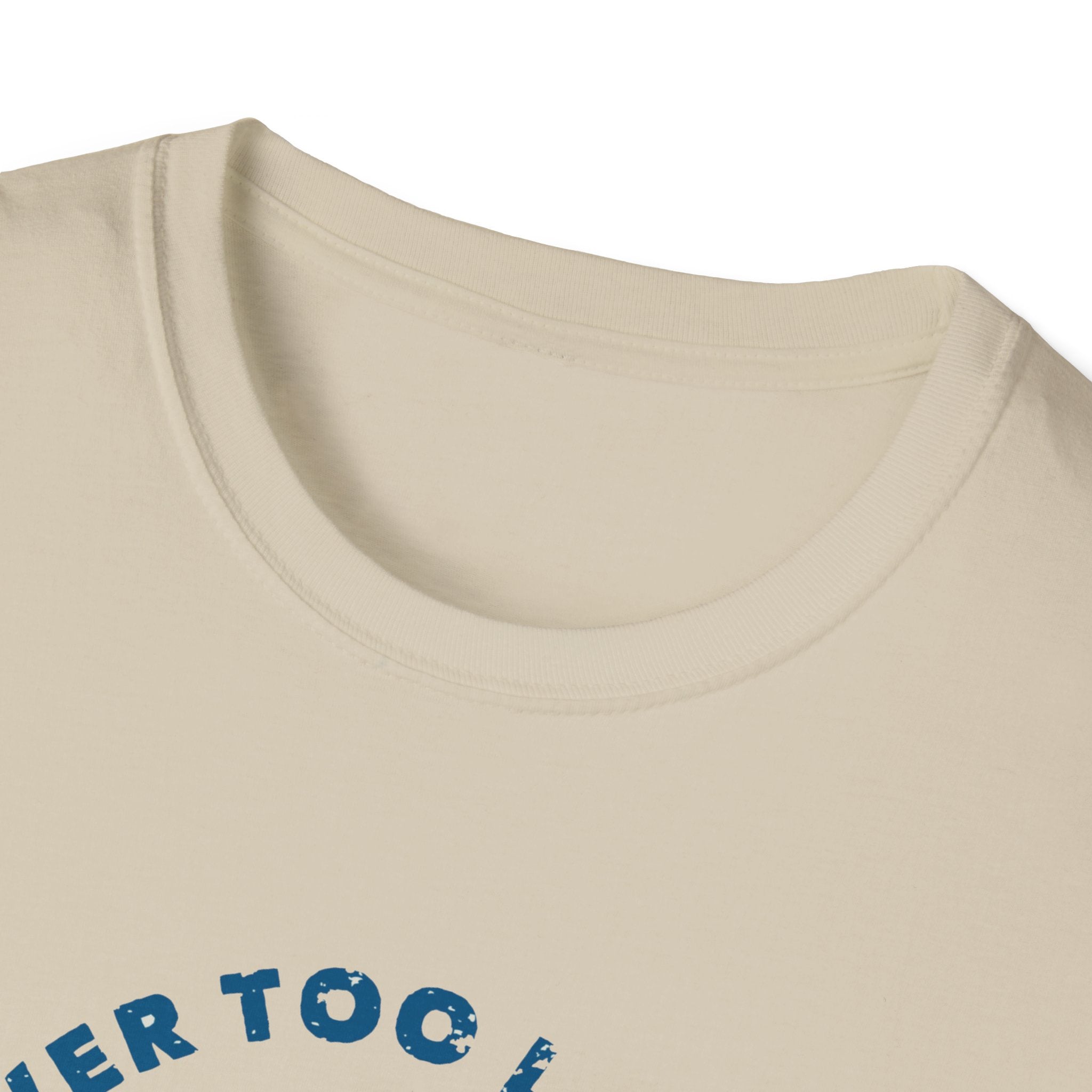 Close-up of the neck of a cream-colored "Never Too Late to Skate T-Shirt," with blue printed text partially visible at the bottom of the image.