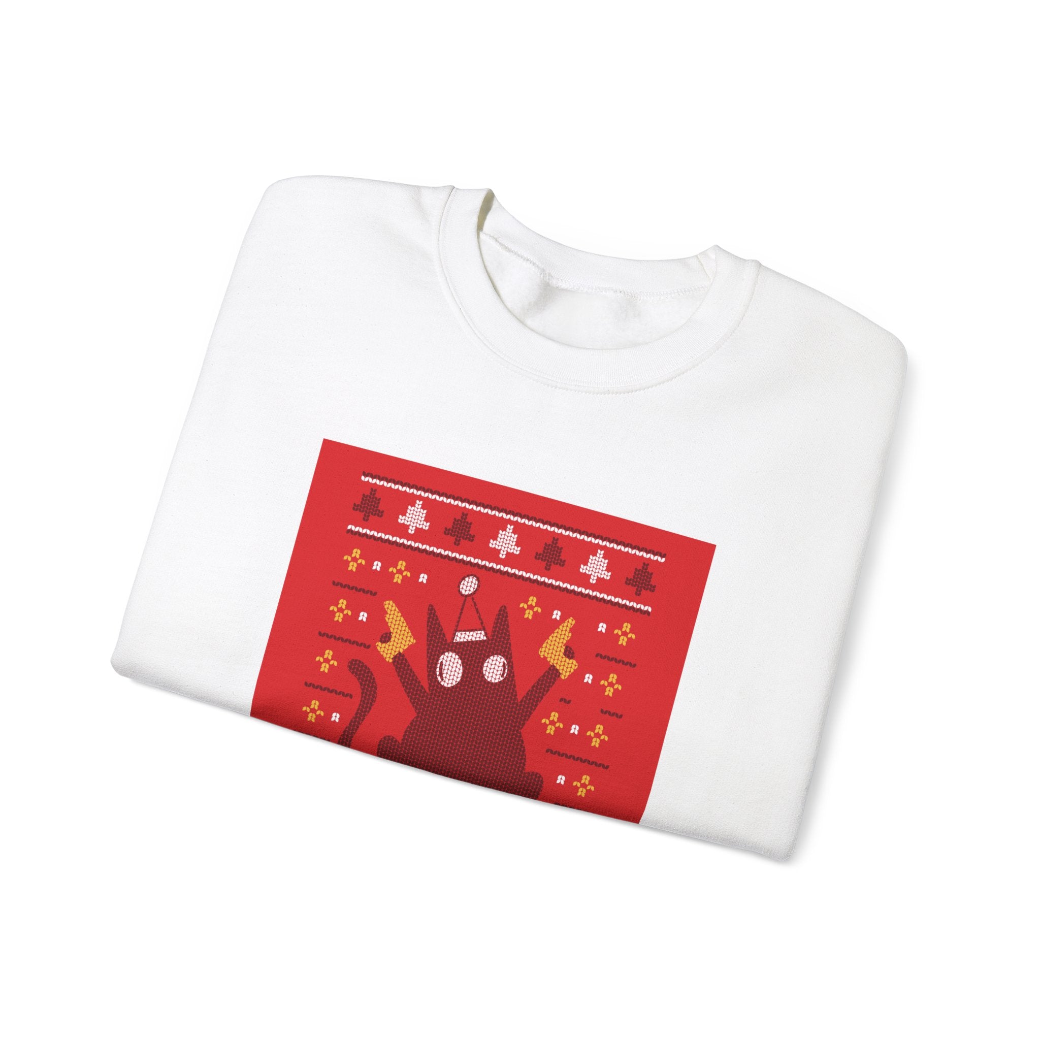 The Ugly Sweater Cat - Sweatshirt is a folded white sweatshirt with a red holiday-themed cat, yellow and white accents, and pixel art-style decorations—perfect for geek and nerd culture fans.