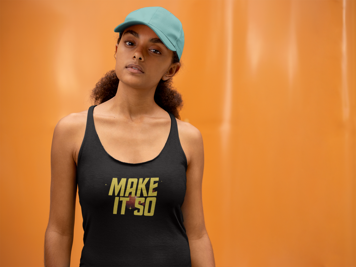 'Make It So Tank' in black, woman by an orange wall, Tank Top mockup, Geekpsters