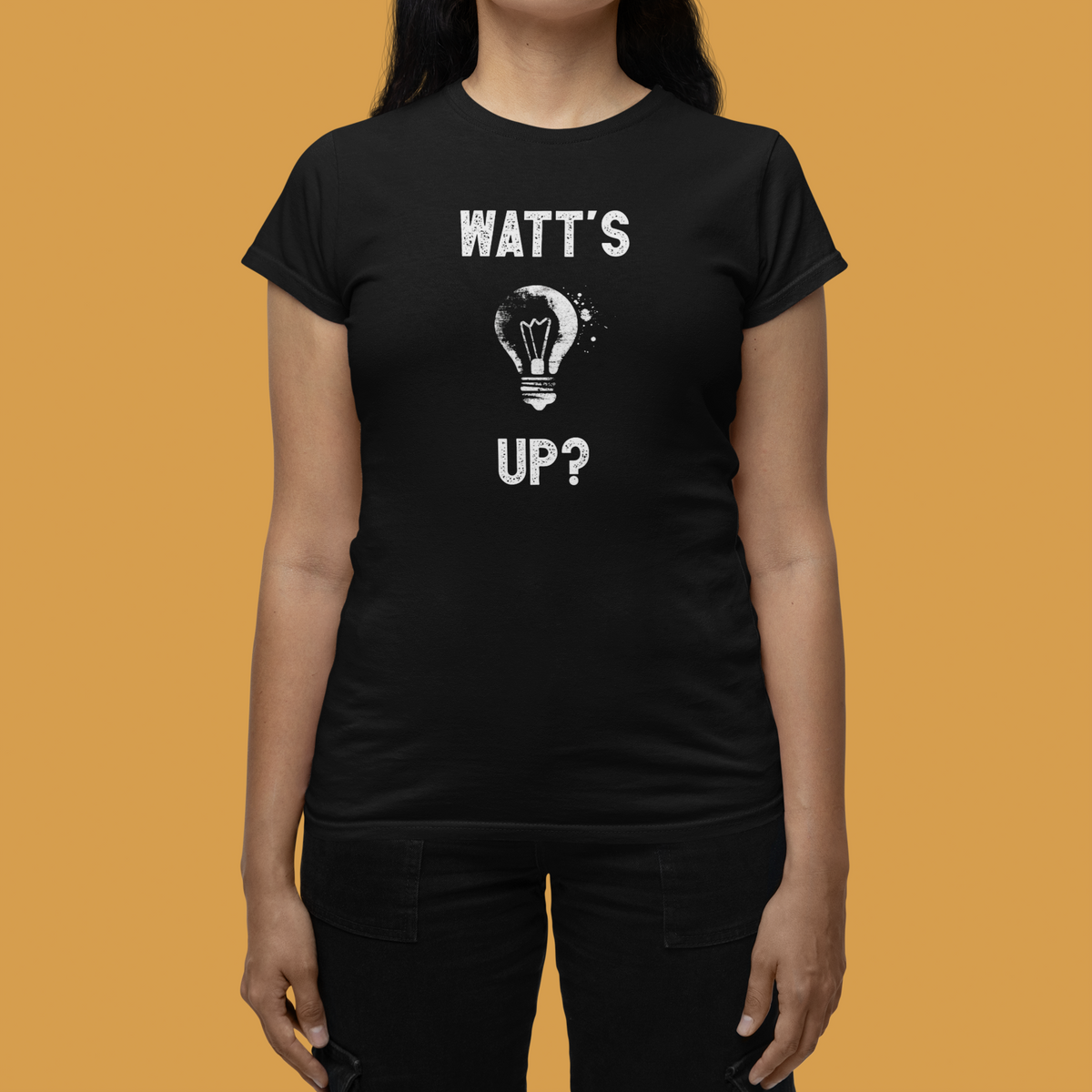 'Watt's Up?' women's tee in black, woman on mustard background, funny electrician pun tee gift
