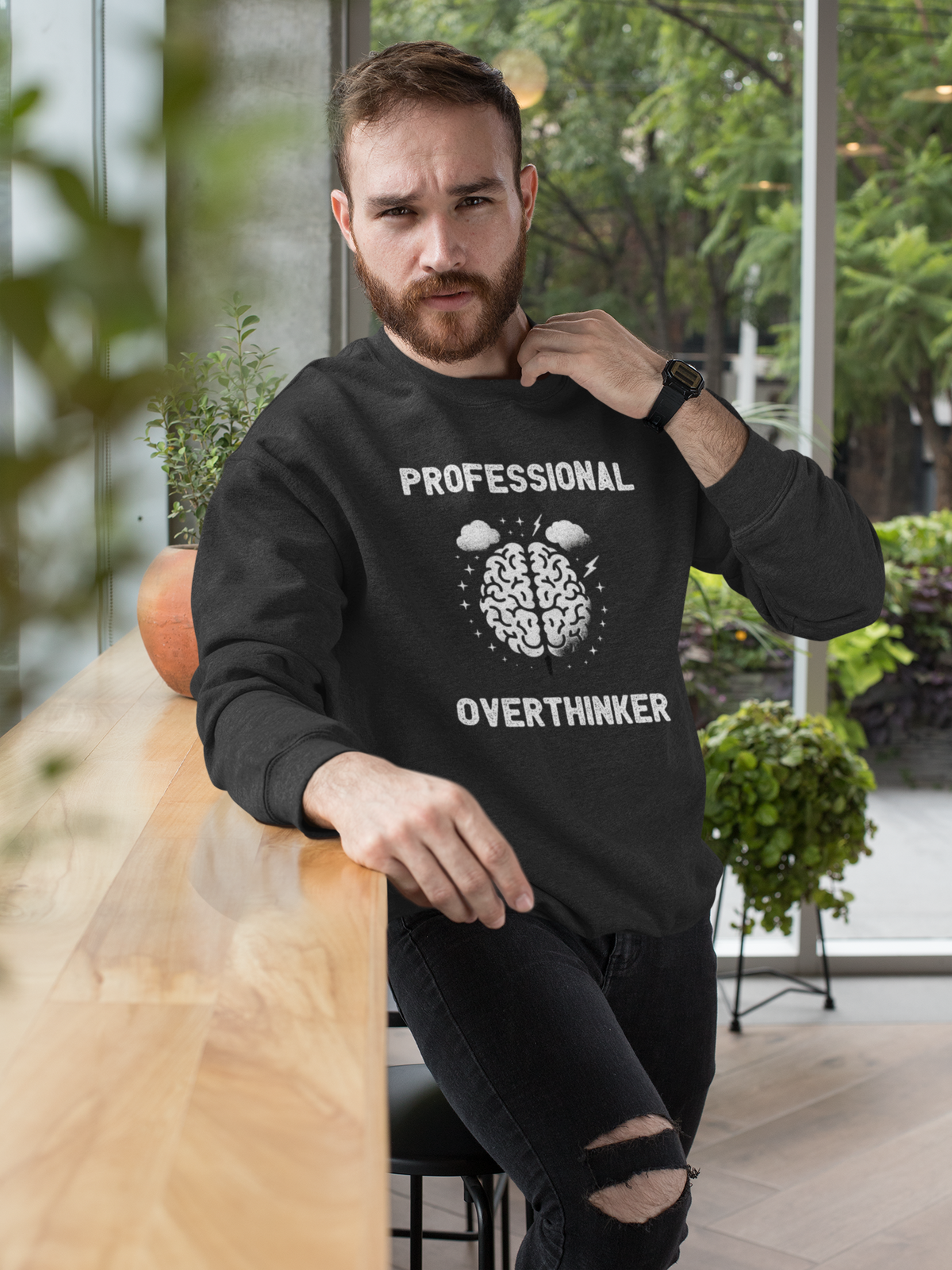 "Professional Overthinker" sweatshirt in black, man modeling it outdoors, funny gift for overthinkers