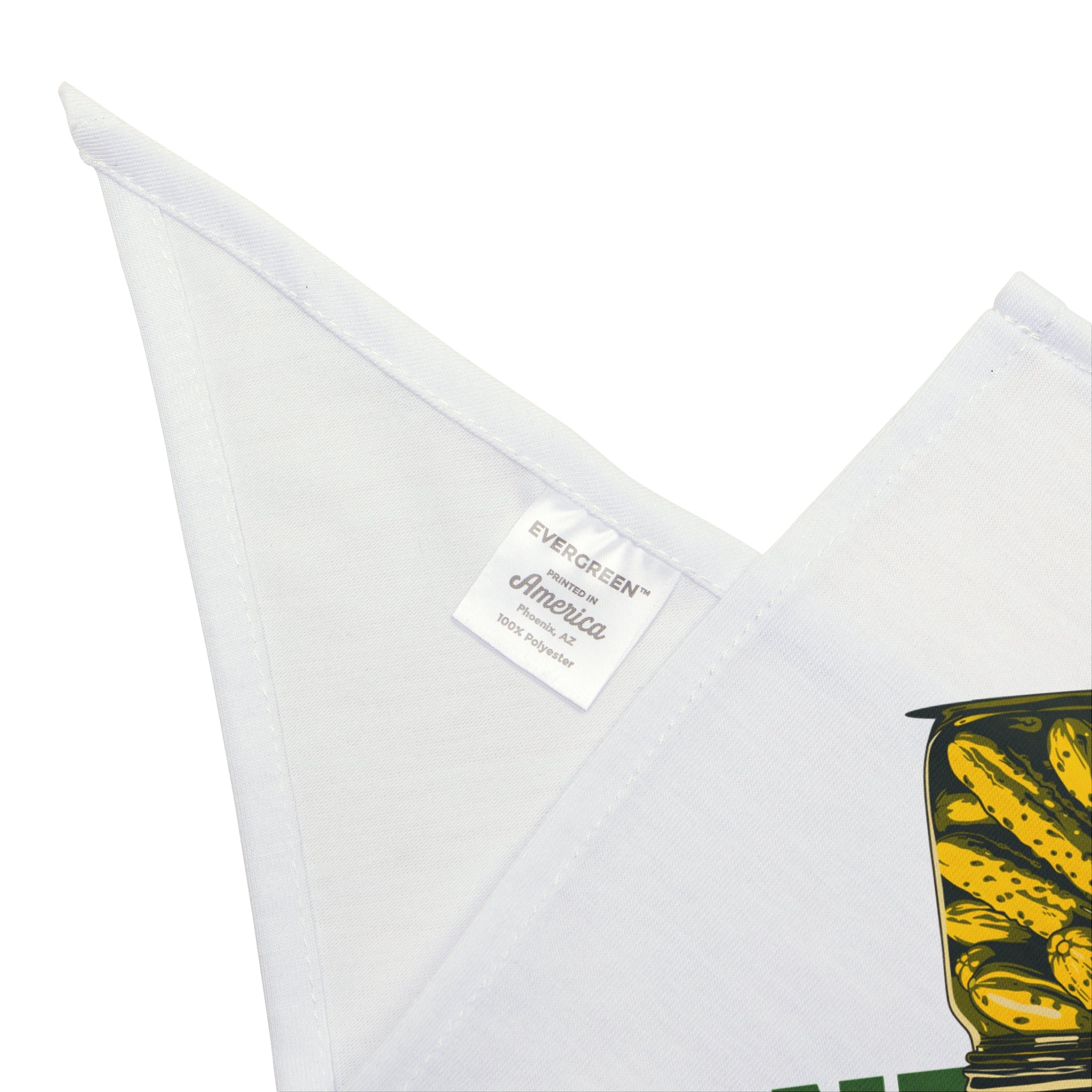 Close-up of a white fabric featuring the "Dill Seeker - Pet Bandana" label with part of a yellow and green print, perfect for giving your pet's look a subtle touch of geek chic.