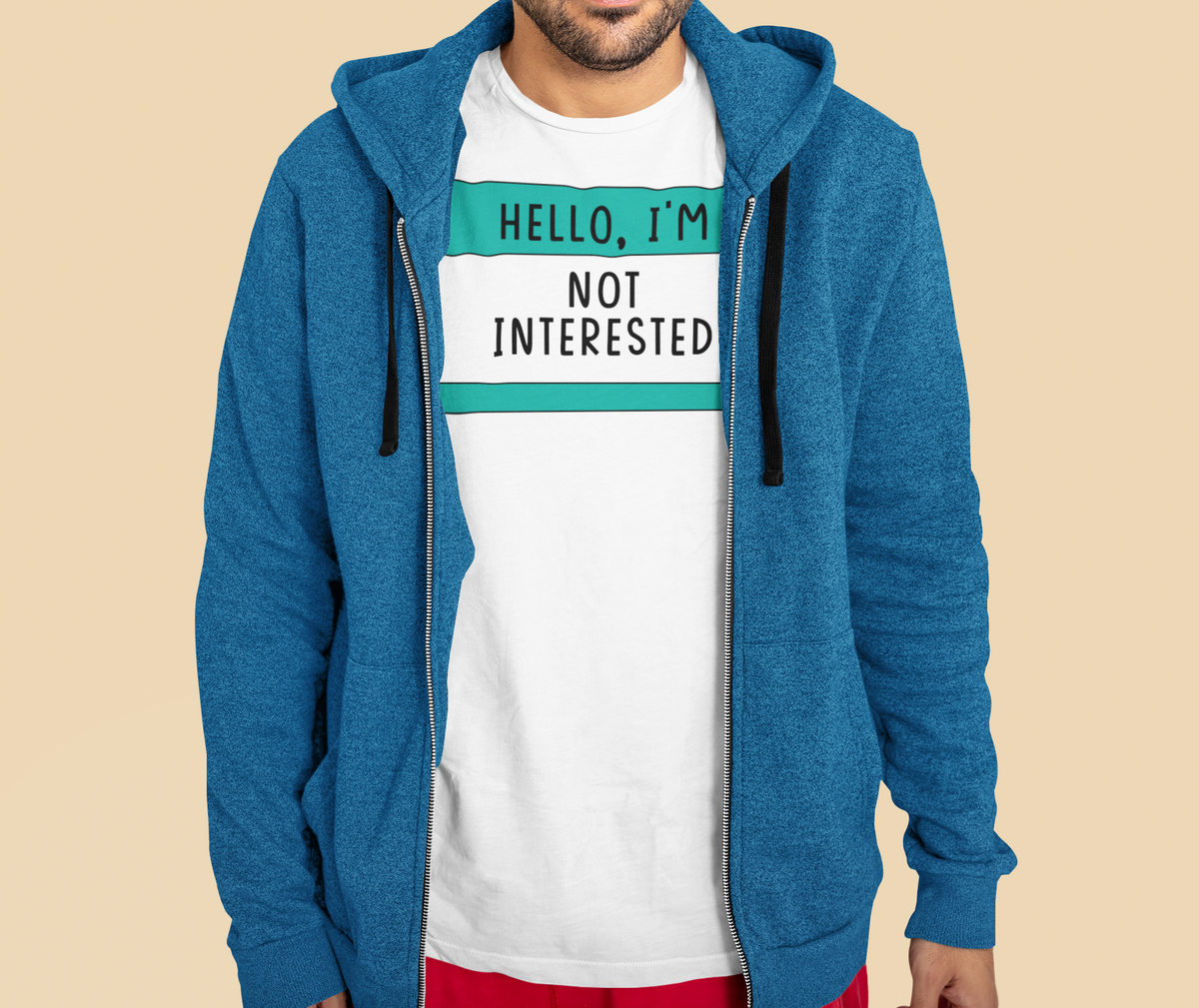 Hello I'm Not Interested name tag T-shirt in white, man wearing denim jacket over it, sarcastic gift tee
