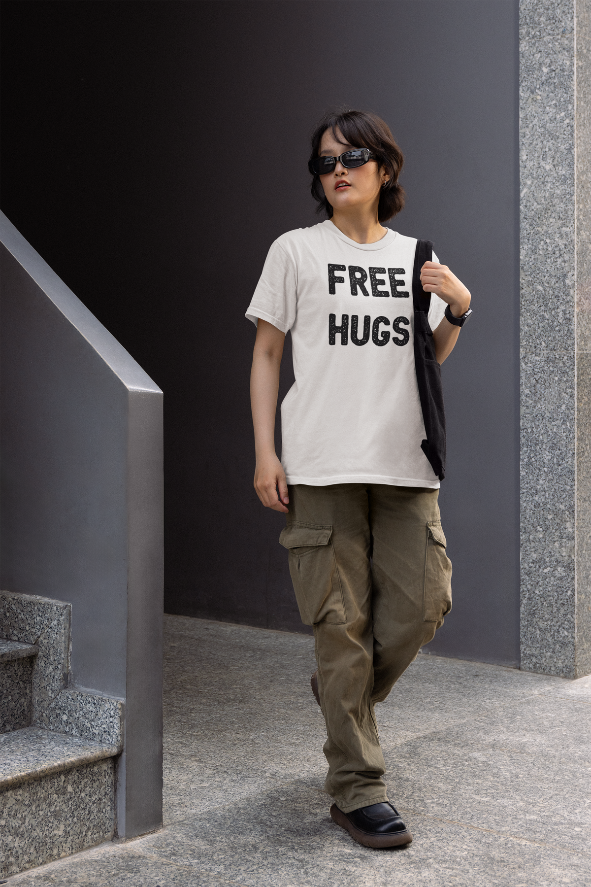 'Free Hugs' women's tee in white, man wearing it outdoors, funny sarcastic shirt gift idea