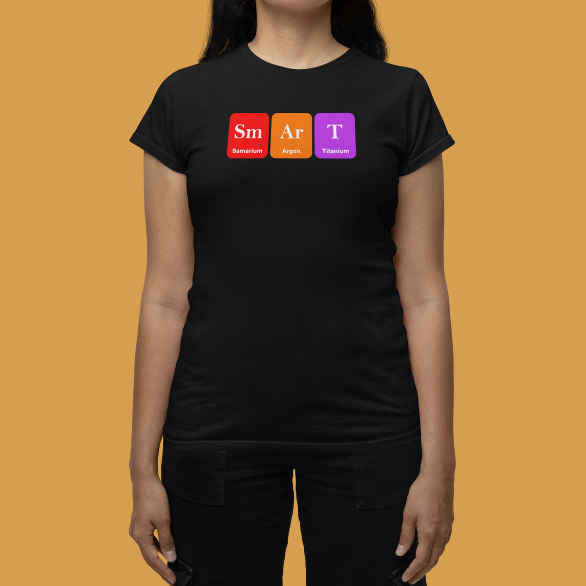 'Smart' periodic table women's t-shirt in black, close-up on model, orange backdrop, funny science pun gift