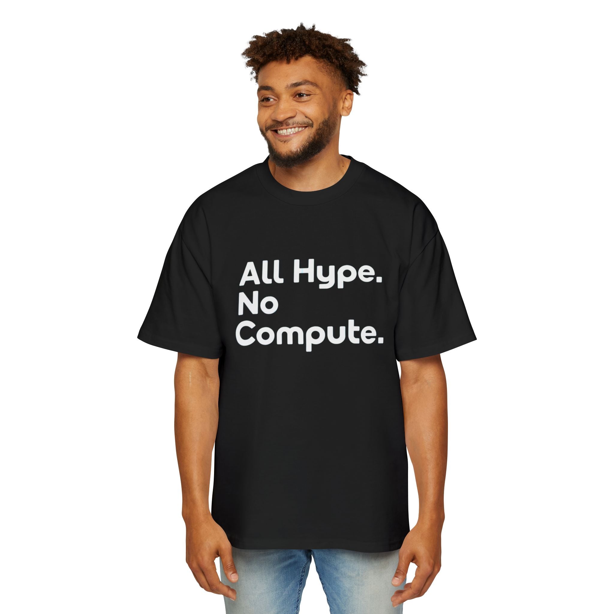 A man wears the ALL HYPE NO COMPUTE - Heavy Oversized Tee, crafted from 100% carded cotton and boldly featuring "All Hype. No Compute." in white on the front—delivering a cozy, oversized fit.
