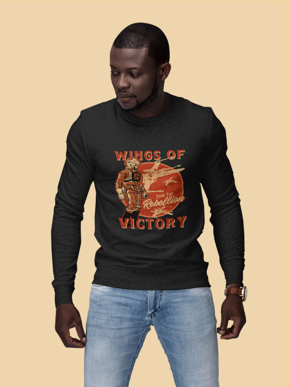 'Wings of Victory' sweatshirt in black, man wearing it on tan background, warrior graphic crewneck gift