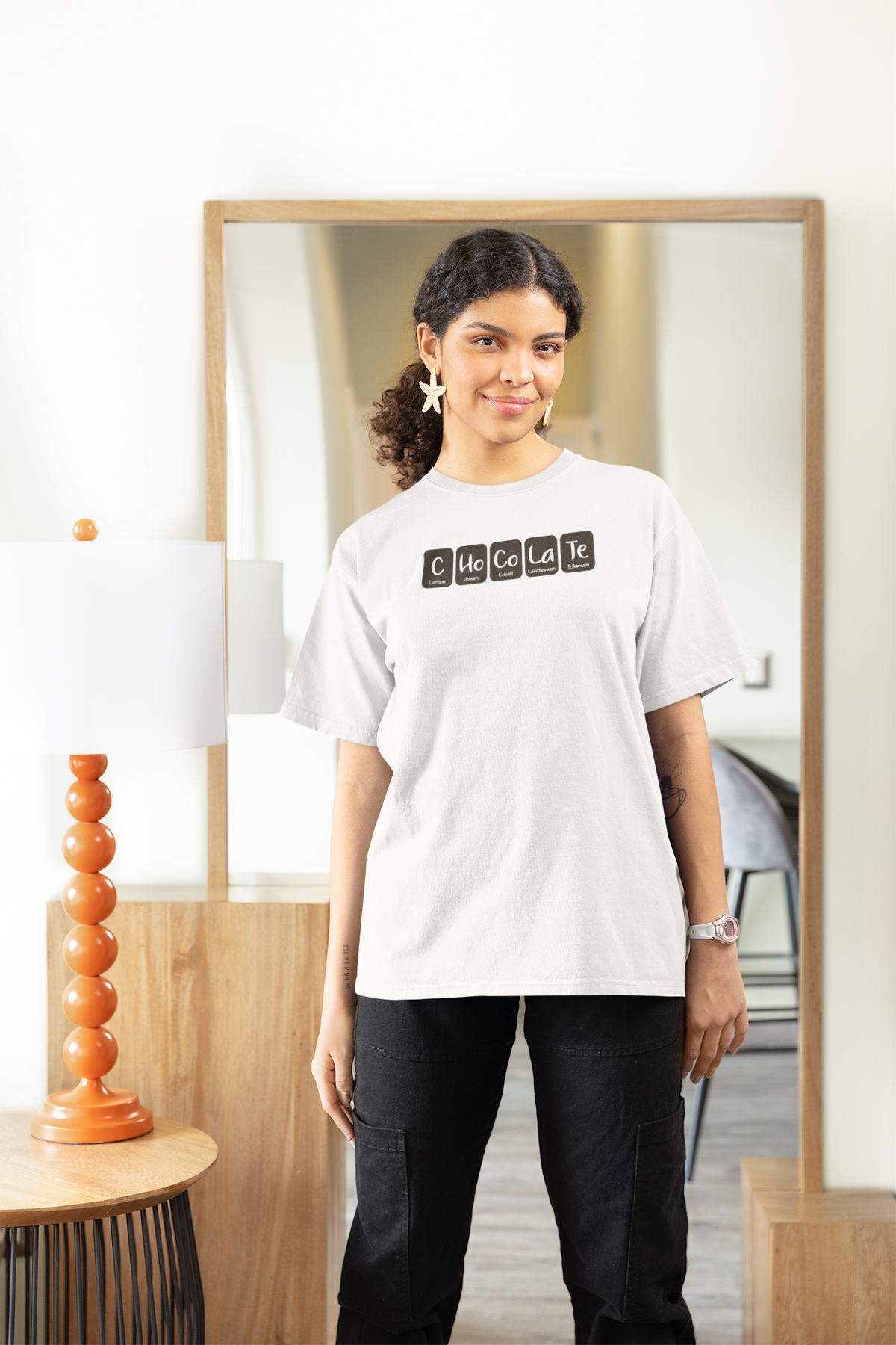 'Chocolate' women's fitted t-shirt in white, woman wearing it oversized at home, cozy foodie gift