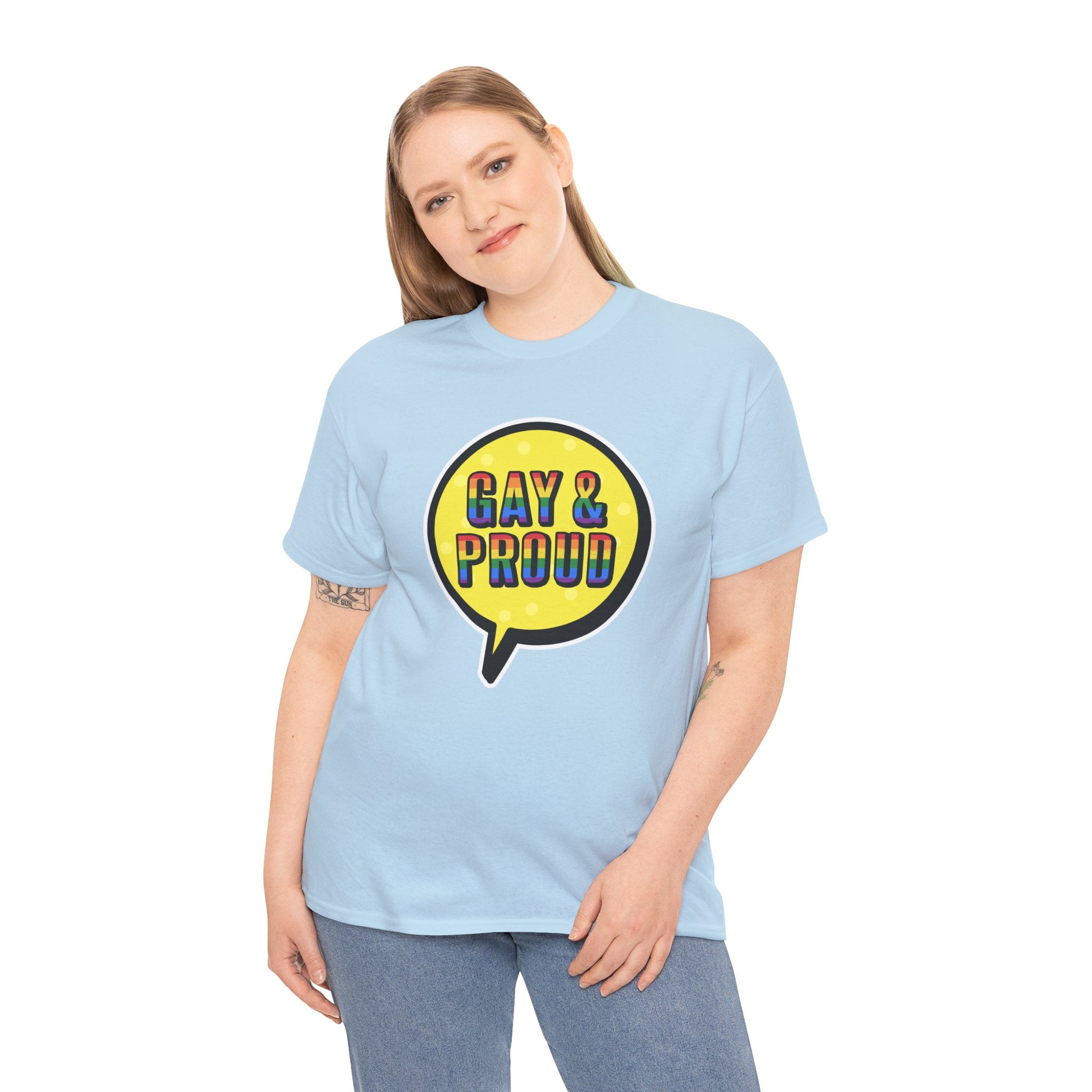 Person wearing the Gay & Proud T-Shirt, a comfortable light blue cotton piece featuring a speech bubble design, ideal for everyday wear.