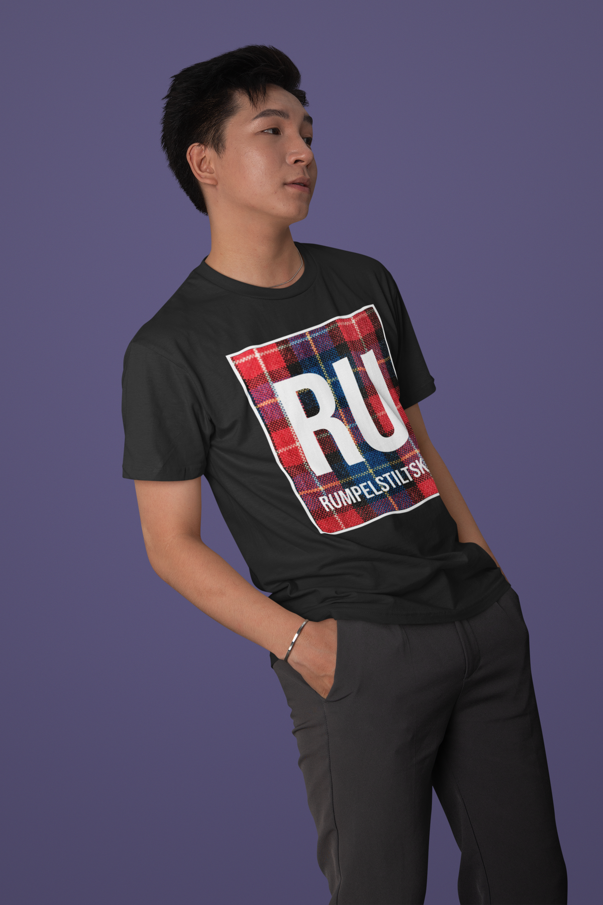 'RU Rumpelstiltskin' periodic table t-shirt in black, man posing on purple background, funny pun gift