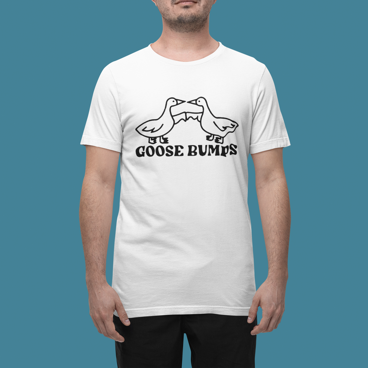 "Goose Bumps" t-shirt in white, man wearing it on a teal backdrop, funny pun gift t-shirt